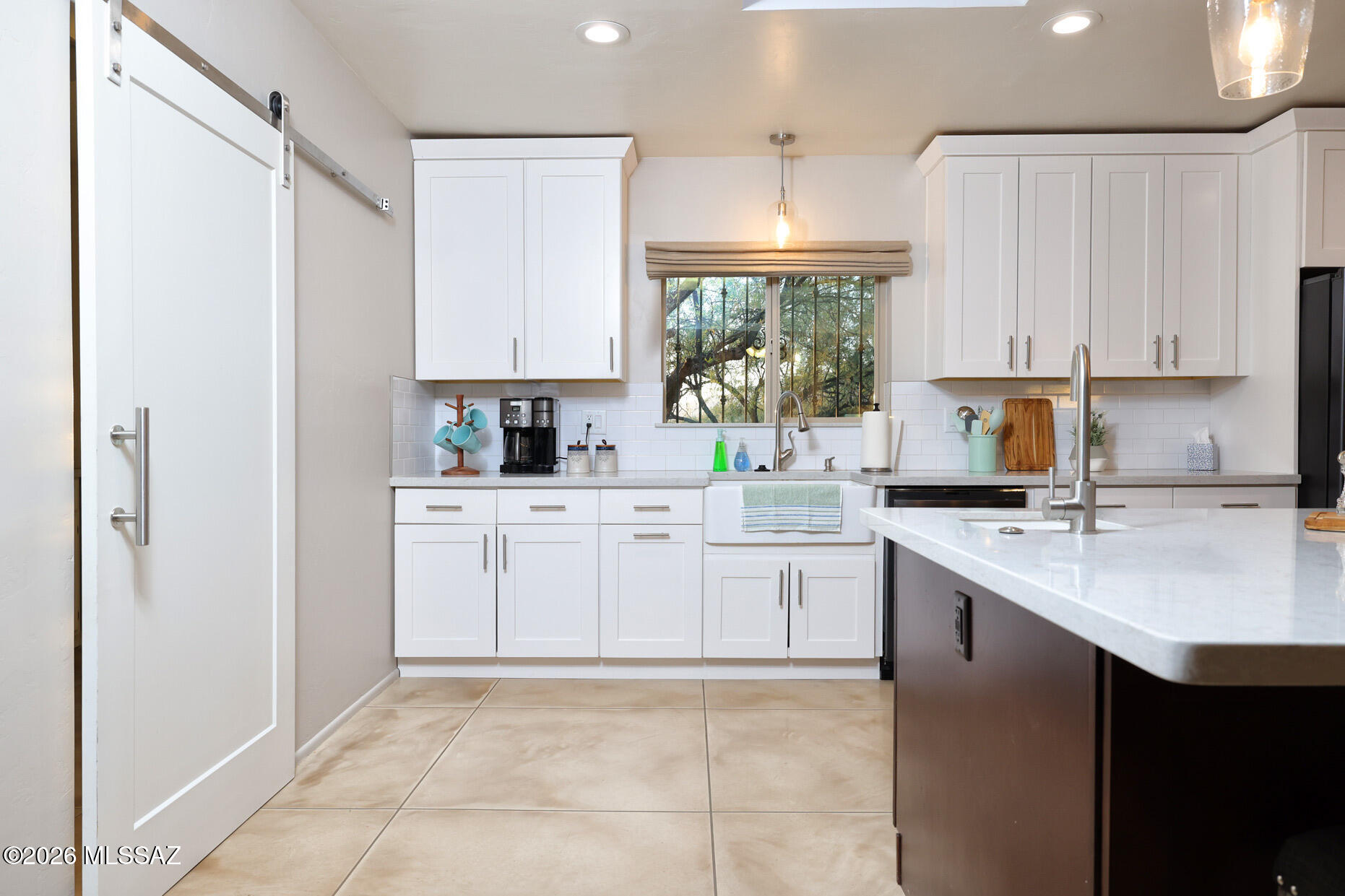 ABLE TO SHOW DURING COMING SOON!!! Beautifully updated 2,144 sq ft home located in the highly sought-after eastside neighborhood of Tanque Verde Acres. This 3-bedroom, 2-bath property offers a spacious and functional layout designed for both everyday living and entertaining. The kitchen features granite countertops, a breakfast bar, and ample prep space, opening to comfortable living areas highlighted by a striking see-through fireplace shared between the living and family rooms. Stained concrete flooring adds modern character, while new carpet in two bedrooms provides comfort and warmth. The primary suite includes a large walk-in closet and an upgraded ensuite bath with dual granite vanity sinks, a spacious walk-in shower with bench seating, and a rain shower head. Additional features include skylights in the kitchen, ceiling fans throughout, and energy-efficient dual-pane windows. Enjoy outdoor living with a generous backyard patio ideal for entertaining. The expansive lot offers plenty of space for RV parking or the potential to add a pool. A 2-car garage with an attached workshop room provides added flexibility. With no HOA and move-in ready condition, this property also presents an excellent opportunity as a short-term rental investment, offering strong appeal for guests seeking space, comfort, and a desirable location.
Don't miss your chance to own this versatile and inviting home!