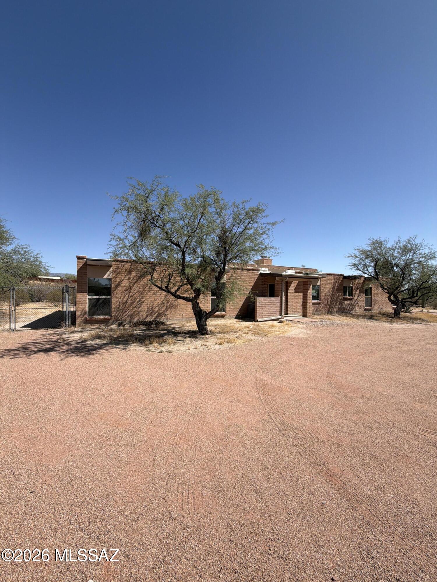 ABLE TO SHOW DURING COMING SOON!!! Beautifully updated 2,144 sq ft home located in the highly sought-after eastside neighborhood of Tanque Verde Acres. This 3-bedroom, 2-bath property offers a spacious and functional layout designed for both everyday living and entertaining. The kitchen features granite countertops, a breakfast bar, and ample prep space, opening to comfortable living areas highlighted by a striking see-through fireplace shared between the living and family rooms. Stained concrete flooring adds modern character, while new carpet in two bedrooms provides comfort and warmth. The primary suite includes a large walk-in closet and an upgraded ensuite bath with dual granite vanity sinks, a spacious walk-in shower with bench seating, and a rain shower head. Additional features include skylights in the kitchen, ceiling fans throughout, and energy-efficient dual-pane windows. Enjoy outdoor living with a generous backyard patio ideal for entertaining. The expansive lot offers plenty of space for RV parking or the potential to add a pool. A 2-car garage with an attached workshop room provides added flexibility. With no HOA and move-in ready condition, this property also presents an excellent opportunity as a short-term rental investment, offering strong appeal for guests seeking space, comfort, and a desirable location.
Don't miss your chance to own this versatile and inviting home!