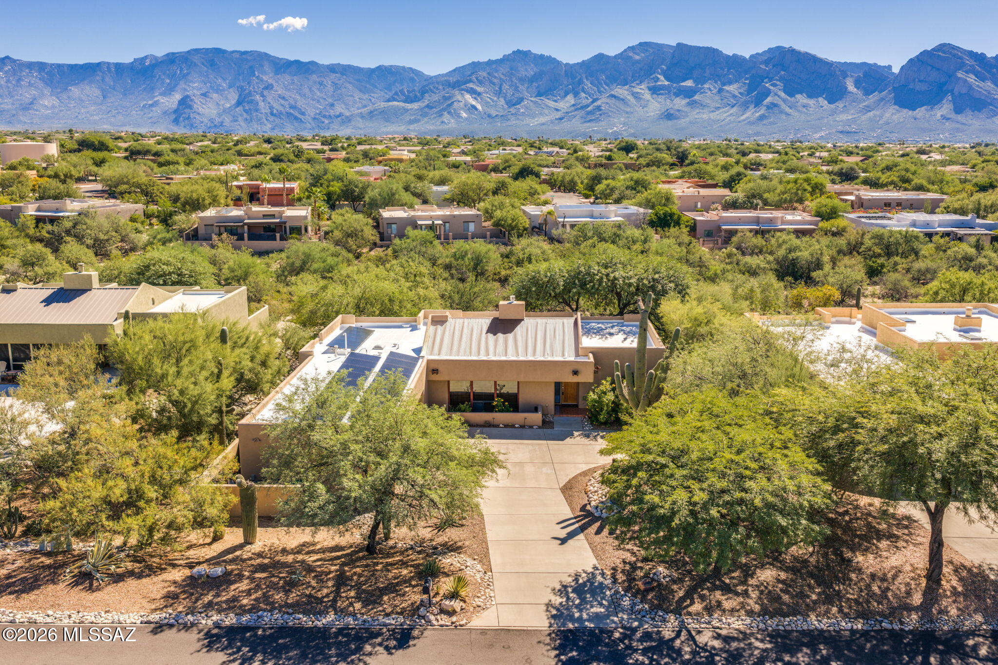 Embrace stunning mountain views with this custom-feeling, Tyson-Murphy contemporary residence tucked away inside the heart of Oro Valley. Delivering an exceptionally roomy 4BD/2BA+3.5 car garage (2,220 sqft) of living space, this home balances artistic design accents with everyday functionality. Situated on an expansive lot, the property guarantees maximum physical separation and absolute privacy. The home has a dramatic architectural layout framed by towering ceilings, high display ledges, and unique accent windows. All primary common spaces boast massive 7-foot windowpanes that frame front-row views of the local mountain ranges while inviting a steady stream of Southern Arizona sunshine inside. The heart of daily routines is a beautifully updated chef's kitchen, complete with solid granite countertops, a functional central workflow, and premium stainless steel appliances. The rear grounds serve as a picture-perfect desert oasis engineered for effortless outdoor entertainment. Step out onto the covered back patio to enjoy a manicured combination of green grass, mountain views, and a tranquil fountain setup. Car collectors and adventure enthusiasts will love the massive 3.5-car attached garage, providing immense space for full-sized trucks, tools, or recreational desert toys. Perfectly positioned right in the center of Oro Valley, you enjoy a private, lower-density pocket that sits within short distance to premium shopping centers, grocery hubs, and local dining areas.