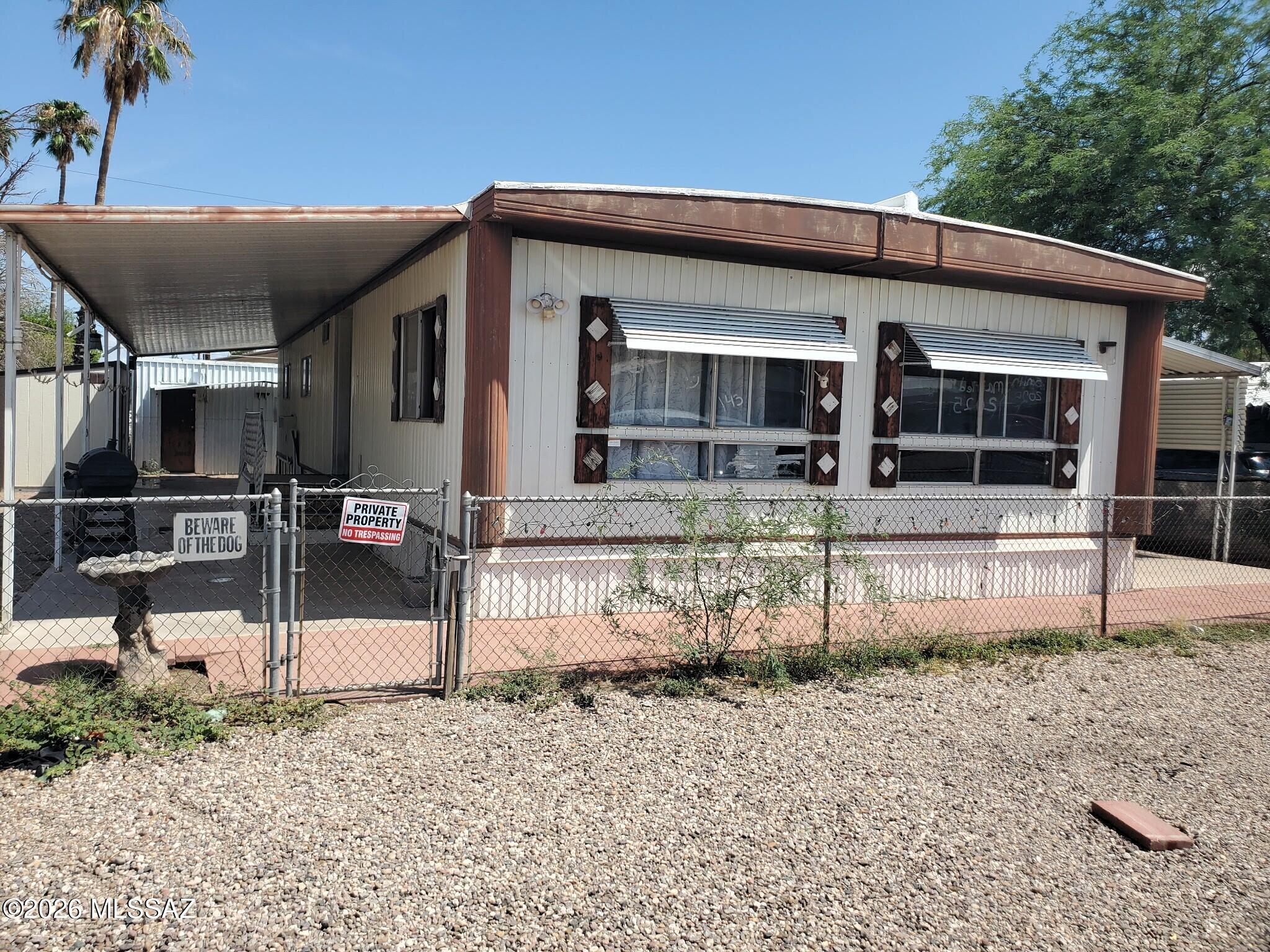 Investor Special with Incredible Income Potential - No HOA! Unlock excellent cash-flow potential with this unique multi-structure property in Tucson! The main residence is a spacious, 1,440-square-foot Lance double-wide manufactured home featuring a functional 2-bedroom, 2-bathroom layout. The standout feature of this property is the second structure located in the rear, offering a versatile space may serve as an ideal (ADU), guest house, or rental unit. The large yard is entirely fenced for maximum privacy and includes two storage sheds for extra utility. All appliances convey with the sale, minimizing your upfront setup costs. Situated with fast access to I-10 and local shopping, this property offers peak convenience for tenants or owners. AS-IS CASH.