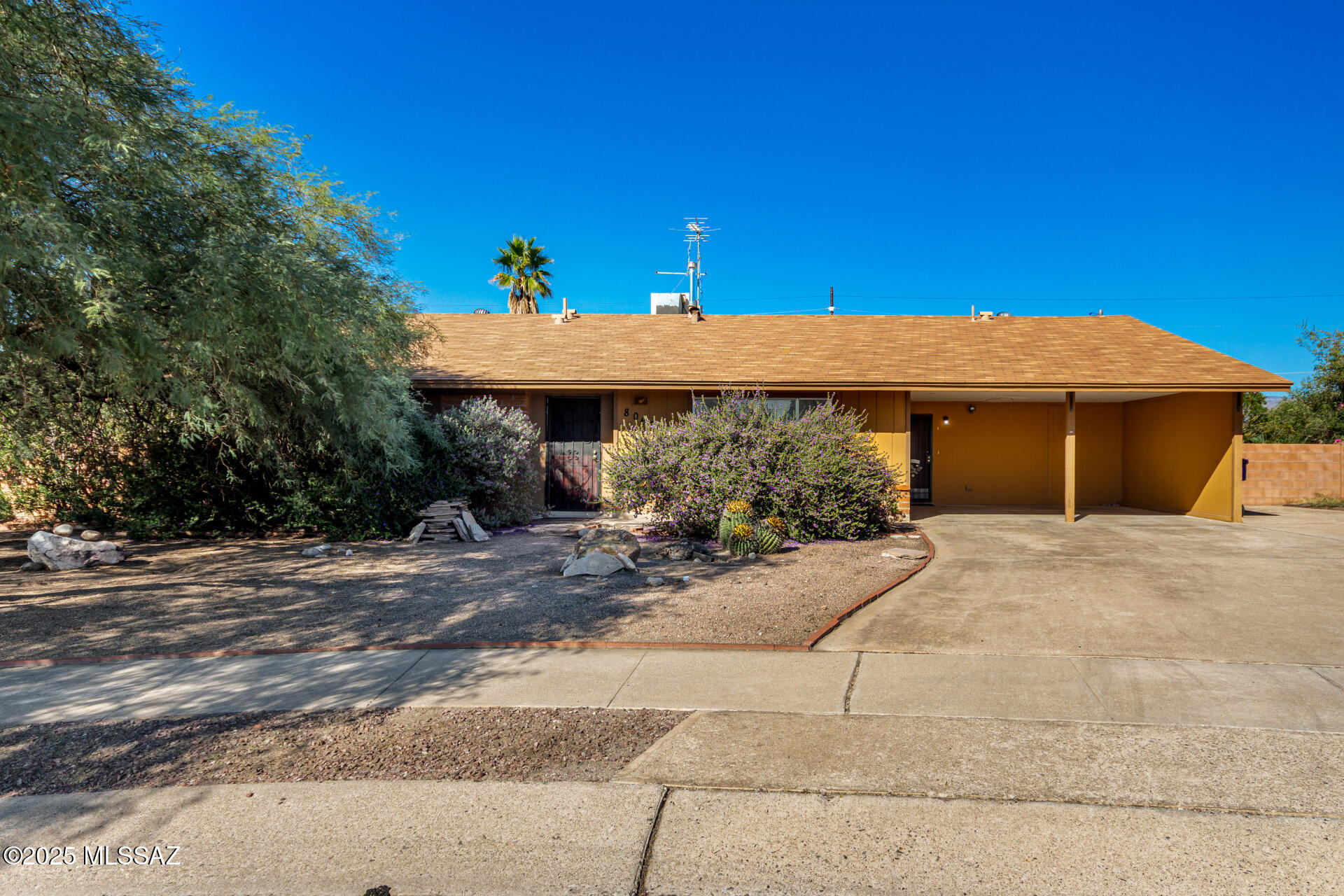 Welcome home to this charming single-level gem with plenty of personality! Enjoy effortless living with a cozy living room perfect for entertaining and a family room pre-wired for surround sound perfect for movie nights. The kitchen is a dream come true with stainless steel appliances, white cabinetry, ample counters, a breakfast bar, and even a serving window to the sunny AZ room. All bedrooms promise restful nights, while the AZ room invites you to unwind with your favorite drink and good company. With wood-look floors in all the right places, a convenient carport, and a location close to schools and local amenities, this delightful home truly has it all! Act now!