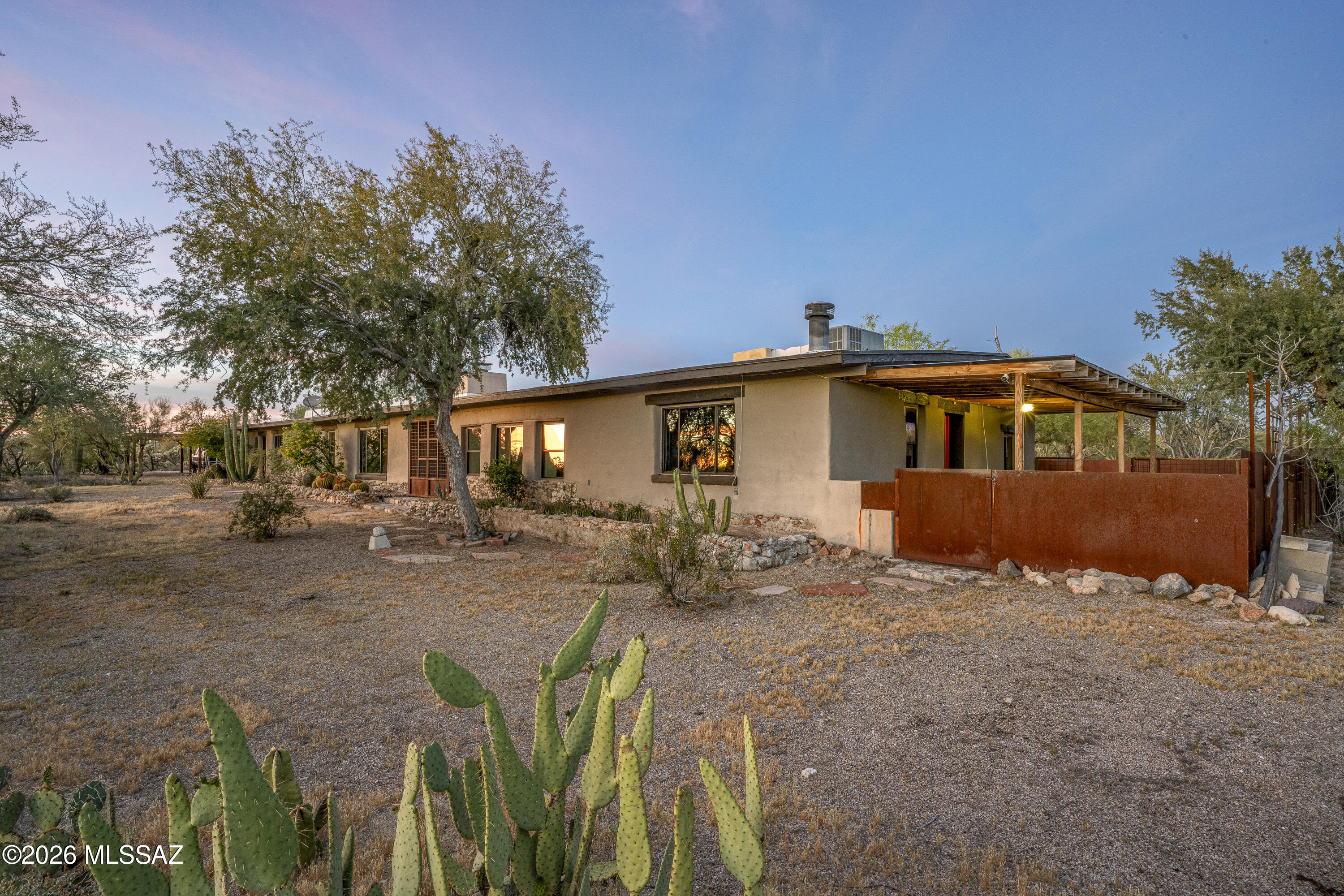 LARGE PRICE REDUCTION, PRICED TO SELL! Experience the perfect blend of rustic charm and modern luxury at this stunning desert retreat nestled on 5.86 private acres. Tucked away for ultimate peace and privacy--yet just minutes from everyday amenities--this unique property offers space, versatility, and timeless appeal.
A unique rammed earth home, the main residence features 4 spacious bedrooms and 2 bathrooms across 2,161 sq. ft., highlighted by fresh interior paint, warm finishes, and an inviting, open layout designed for comfortable living and entertaining. A separate guest house provides an additional 2 bedrooms and 1 bathroom within 1,268 sq. ft., with it's own separate stackable laundry appliances, also freshly painted inside--Ideal for multigenerational living, rental income, or hosting extended guests with ease.

Step outside and enjoy true Arizona living with a sparkling in-ground pool installed in 2019, surrounded by 18 acres of Pima County Conservation offers even more privacy. The property is serviced by its own private well, adding both independence and value.
Whether you're looking for a serene homestead, an income-producing opportunity, or a private escape with room to grow, this rare property delivers the best of rustic luxury living.