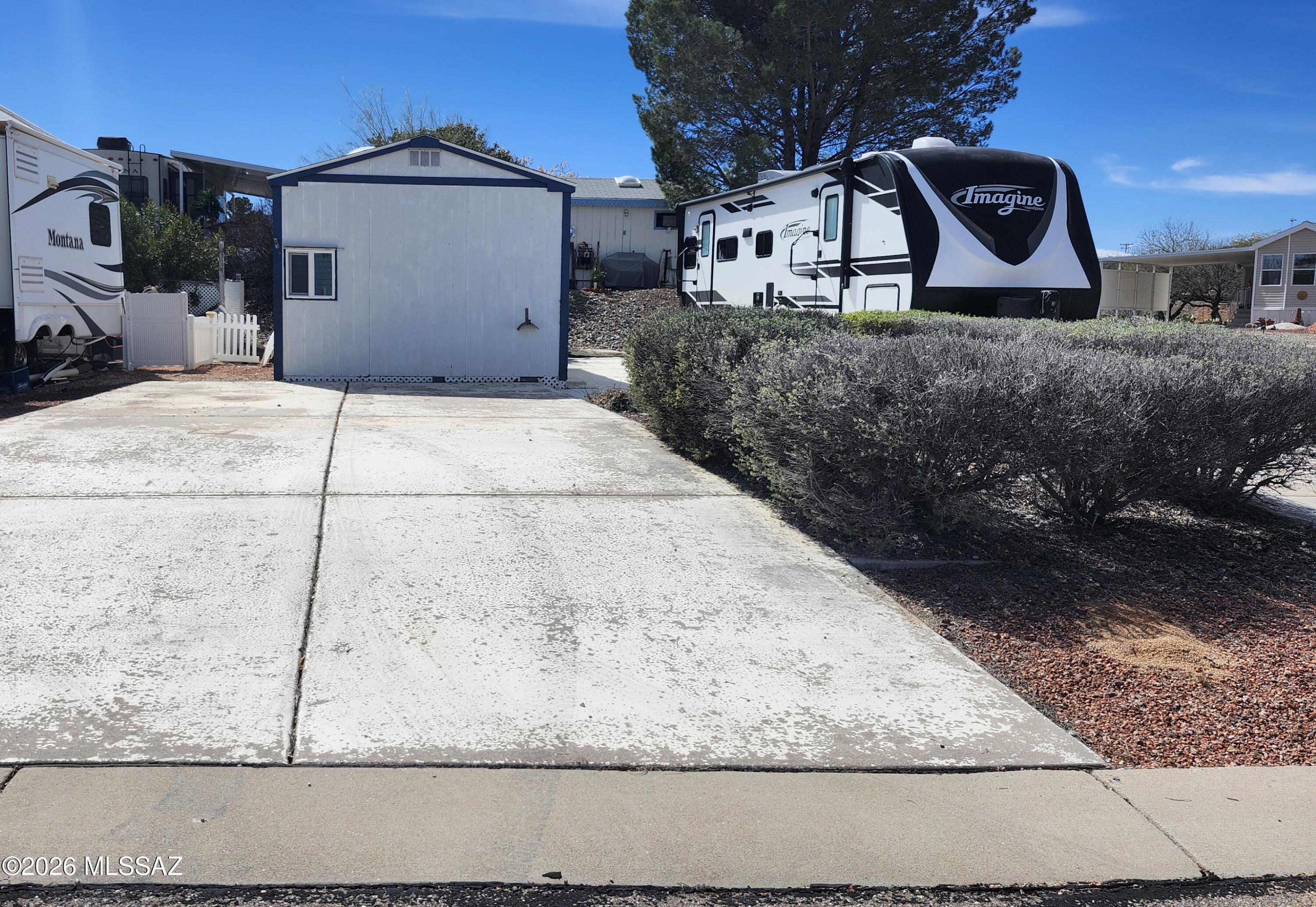 RV lot in the 55+ LOA section of Cochise Terrace. Corner lot with concrete pad for your rig and also a concrete pad for the driveway. Dated storage shed on the property however fully functional for storage or a workshop.