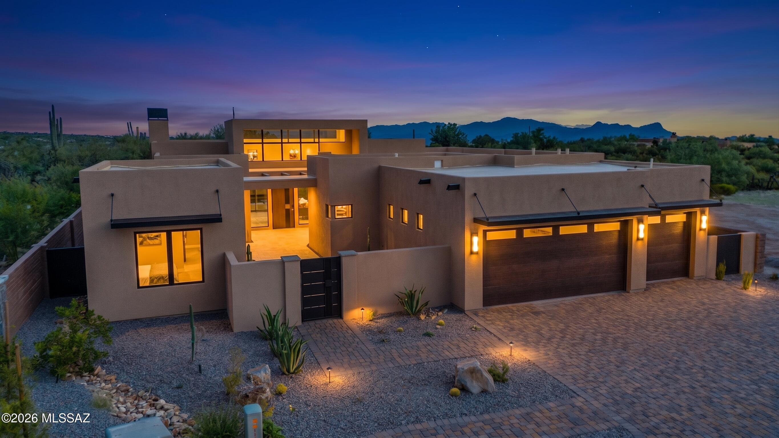 Experience refined desert contemporary living in this brand-new residence at The Ritz-Carlton Residences, Dove Mountain. Designed with a sophisticated neutral palette and exceptional finishes throughout, this stunning home offers two ensuite bedrooms plus a den in the main residence and a private detached guest casita.

Soaring ceilings, 24x48 porcelain tile flooring, custom 8-foot walnut interior doors, and a dramatic 9-foot custom metal entry door create an impressive first impression. The great room is anchored by a striking 72-inch linear fireplace with a textured porcelain facade extending to the ceiling.

The chef's kitchen showcases custom walnut cabinetry with soft-close doors and drawers, luxurious quartzite slab countertops, and premium Sub-Zero and Wolf appliances. Designed for effortless indoor-outdoor living, the backyard is truly spectacular, offering a sparkling pool and spa with unobstructed, up-close mountain views overlooking the natural desert and golf course beyond. With no homes directly behind the property, the setting offers a rare sense of privacy and tranquility, allowing the surrounding Sonoran Desert landscape to take center stage.

Perhaps best of all, this exceptional residence is within walking distance of The Ritz-Carlton Hotel, placing world-class resort amenities, dining, and services just moments from your front door. A rare opportunity to experience brand-new luxury, privacy, and the quintessential Dove Mountain lifestyle.
