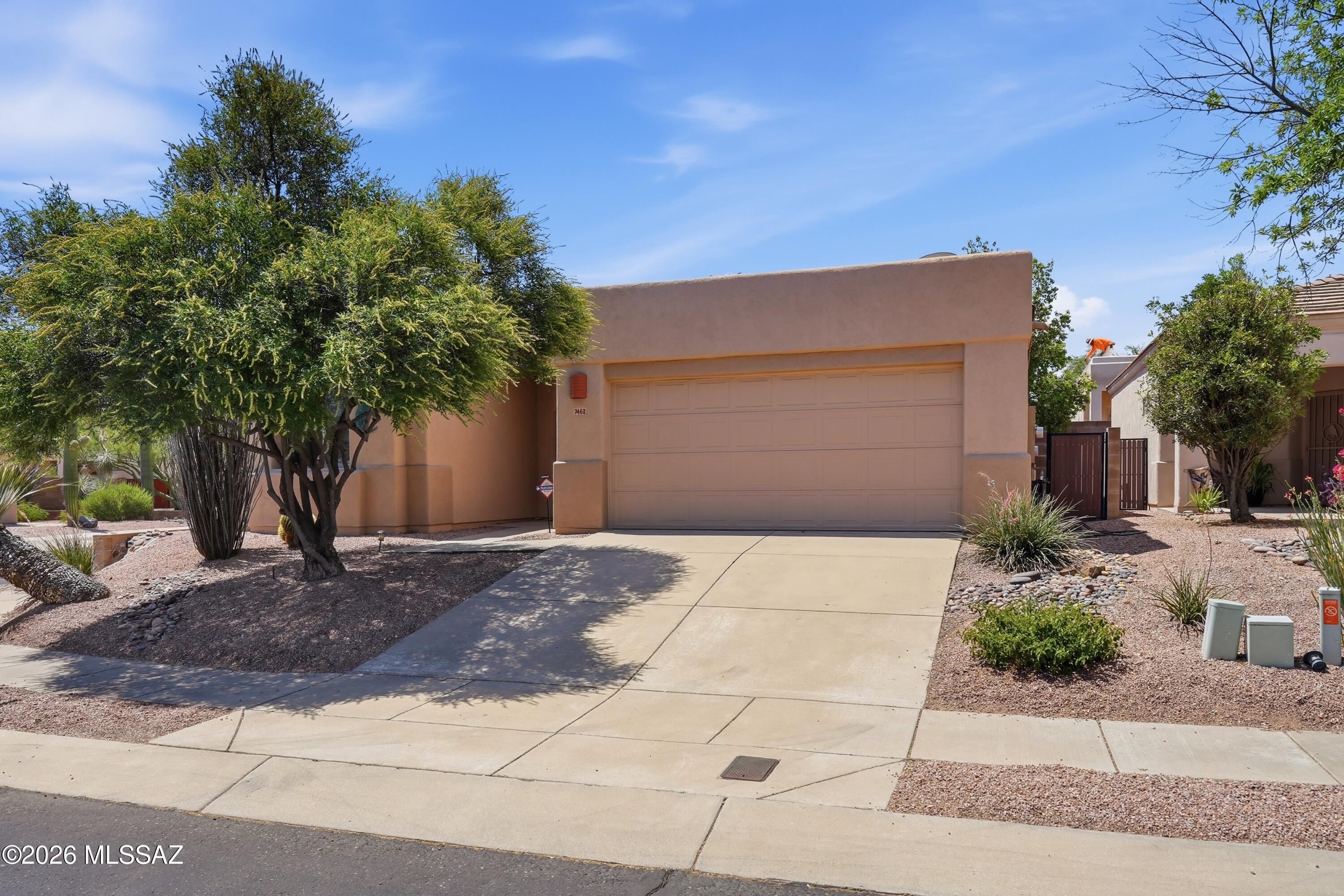 Warm and inviting Santa Fe-style home in the gated Rancho Esperero community, offering access to three sparkling pools, spas and close to the Tucson Loop. This single-level 3BD/2BA features a bright great room with gas fireplace, high ceilings, skylights, and a split bedroom layout. The kitchen includes stainless appliances, breakfast bar, and pantry. The spacious primary suite offers a double vanity and walk-in closet. Enjoy low-maintenance desert landscaping, a covered patio, and a corner-lot setting with mountain views. Owned Solar for energy efficiency. Convenient Northeast location near Sabino Canyon, shopping, and dining.