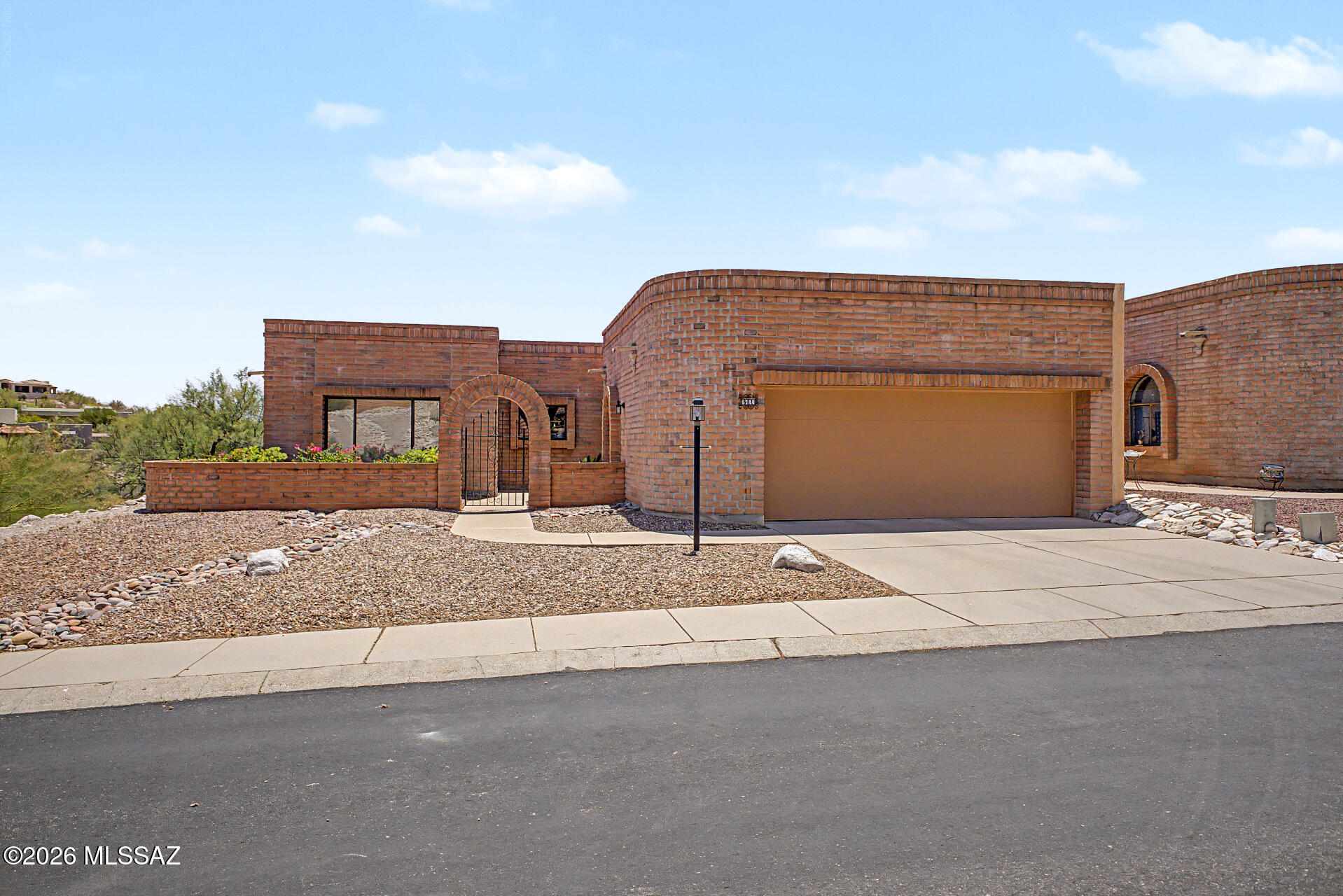 North Tucson living at its finest! End unit San Jose floor plan sitting on beautiful lot above natural green space. This 2 BR, 2 BA beauty has comfortable, well-planned living space on a generous, private lot. Bright, open and airy floor plan includes formal living/dining area and separate flexible and functional den or office off the kitchen. Kitchen features granite counter-tops, beautiful cabinets, and LG Stainless Appliances. Primary suite provides a sense of retreat, complete with a modernized ensuite bath and spacious walk-in closet. Guest and primary baths feature executive height counters. Many upgrades including extended electric awnings and drop down screens on back patio; plantation shutters and verticals throughout; recirculating pump on the water heater; artificial turf on south lawn; gas heat and gas water heater; security door at front entry; sun tint on some windows; recent roof maintenance with 2 year warranty. AC was replaced in 2013 and has a current maintenance agreement. Washer, dryer, and refrigerator convey. Expansive backyard is great for entertaining guests or a quiet evening enjoying the magnificent Tucson sunsets and sparkling city lights. Additional guest parking spots are available just steps away. Convenient to Foothills restaurants, shopping, and top-rated trails, all within easy access.