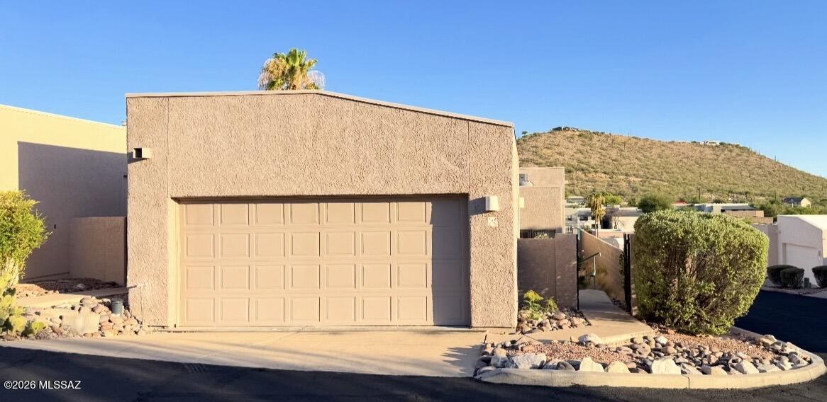 Perched on a corner lot with sunset and mountain views, this 2-bedroom, 2-bath Valle townhome sits at the base of the Catalina Mountains near Sabino Canyon. The bright great room centers on a wood-burning fireplace and opens to the dining area and a private covered patio. Tile and wood-laminate flooring, skylights, and ceiling fans run throughout, with forced-air gas heat and central cooling. The spacious primary suite offers a walk-in closet and its own patio access, and the low-maintenance yard awaits your vision. Residents enjoy a community clubhouse, pool, spa, pickleball and tennis courts, in the top-rated Catalina Foothills School District near shopping, dining, and hiking trails. A standout opportunity in a sought-after foothills location.