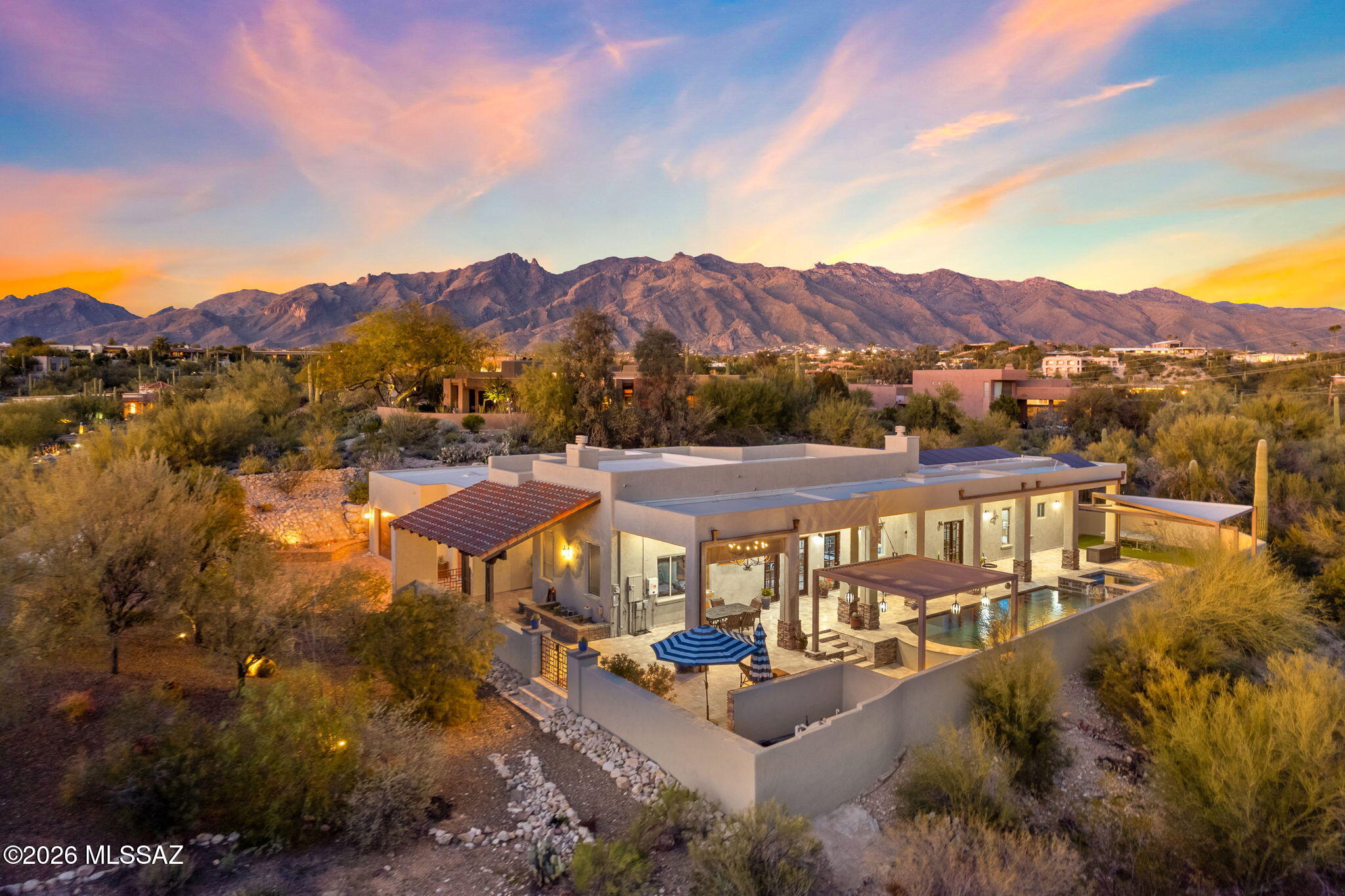Welcome to Bellas Catalinas, an exceptional estate nestled within a private, gated Foothills community, offering over 4,100 square feet of refined living space and a rare combination of luxury, comfort, and energy efficiency. Through the grand double-door entry, soaring ceilings, designer lighting, and elegant chiseled-edge travertine flooring set the tone throughout the home. The residence features 5 oversized bedrooms and 5.5 bathrooms, including 5 ensuite bedrooms, ideal for family living and hosting guests. Expansive living areas anchor the home, highlighted by a dramatic living room with fireplace. The gourmet kitchen is designed for both form and function, featuring Viking and Sub-Zero appliances, pot filler, prep sink, wine refrigerator, and generous workspace. The owner's suite is a private retreat with its own fireplace, oversized walk-in closet, and a spa-inspired bath offering a luxury walk-in shower with dual heads, jetted soaking tub, and dual vanity.
The backyard delivers true resort-style living: a pool and spa with swim-up bar, steel pergola, sunken outdoor kitchen, and custom travertine hardscape. An extended covered patio with chandelier, surround sound, and TV lounge creates an ideal year-round entertainment space. A second private patio and lush artificial turf area complete the setting.
Additional highlights include a three-car extended-length garage with abundant storage, mudroom, and laundry room with sink.
A significant value feature is the 36-panel solar system that is fully owned - not leased - providing substantial long-term energy savings.
If you are ready to add a touch of class to your life, please call today to schedule a private tour or to ask any questions about this magnificent home.