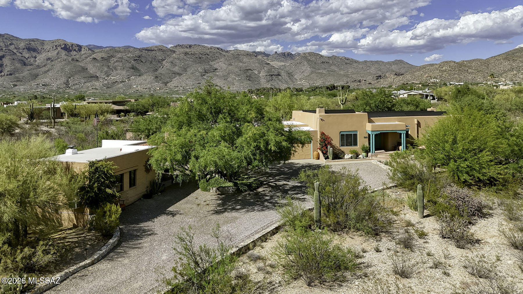 Experience authentic Southwest living in this custom Santa Fe estate with casita on 3.2 acres in the Tanque Verde Valley. Surrounded by natural desert and framed by breathtaking Catalina and Rincon Mountain views, this one-of-a-kind horse property features a 3,328 sq ft main home plus an 839 sq ft casita. Handcrafted details include vigas, Saltillo tile, carved corbels, custom doors and cabinetry, niches, and multiple kiva fireplaces. The spacious primary suite added in 2019 offers stunning views, spa bath, and oversized walk-in closet. Enjoy owned solar, artist studio, sunroom, flagstone patios, and serene outdoor living spaces with sunset views. Located near Agua Caliente Park, Mt. Lemmon, hiking, and within the Tanque Verde School District
