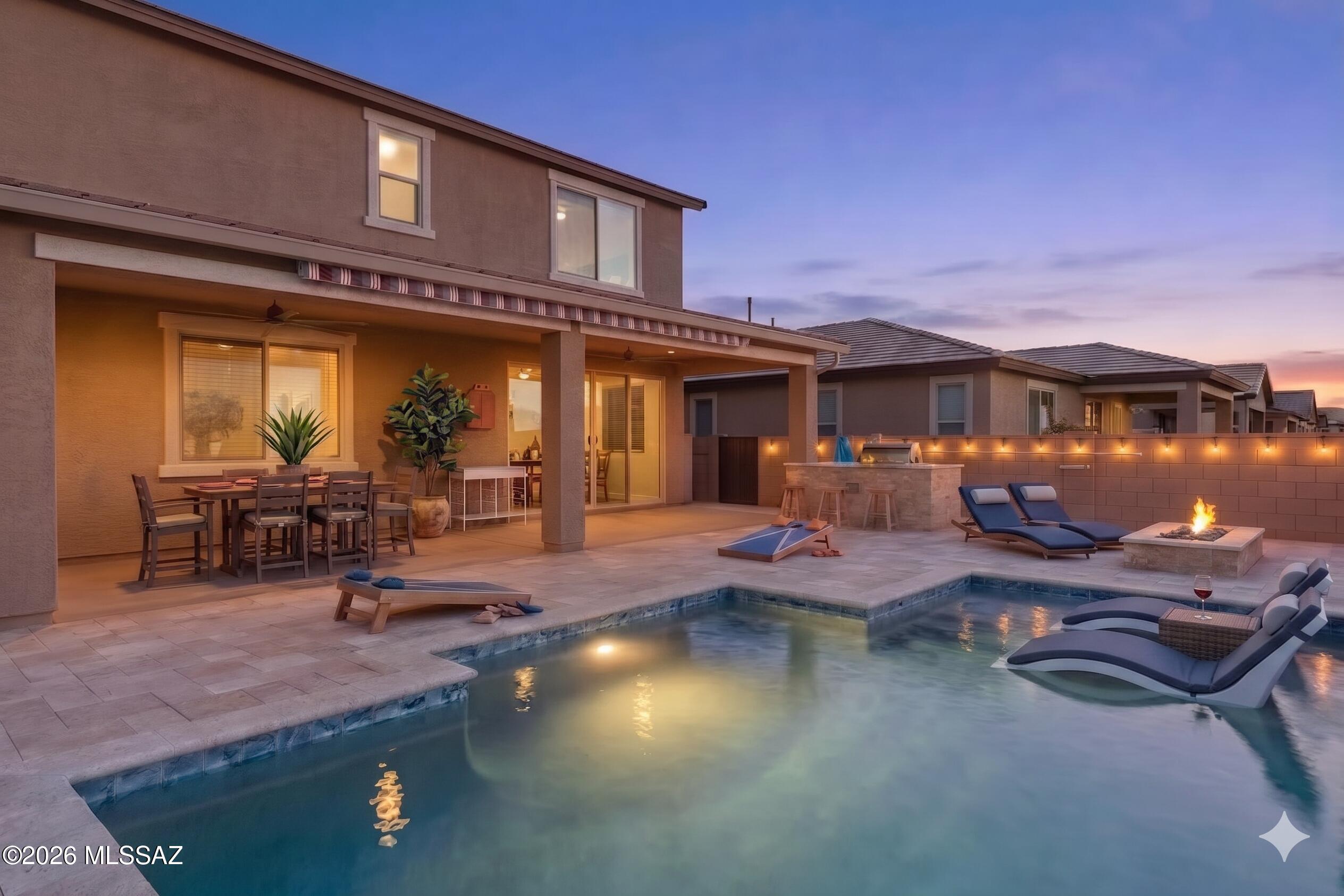 Welcome home to your spacious 2,633' Richmond American home built in 2020 in Vail Schools with a pool, hot tub, outdoor kitchen, gas fire pit, and mountain views as just some of highlights. With 5 bedrooms, 3 full bathrooms, and an upstairs loft, you can spread out with plenty of flexible space. The main floor features a large great room with an upscale, open kitchen with quartz countertops, soft-close cabinets, large island, gas range, walk-in pantry, and under stairs storage. Off the foyer is a bedroom and full bathroom perfect for a mother-in-law suite or guest privacy. At the top of the stairs is a generous-sized loft space and four bedrooms, including the primary retreat with a large walk-in closet. The large backyard is fully landscaped with a double covered porch, salt-water pool, hot tub, outdoor kitchen with gas BBQ, gas firepit, and mountain views.  The extended-length garage, with Tesla charger gives you extra room for larger vehicles. Owned solar is included for lower energy bills, along with a security system with cameras already installed. A dedicated dog run, with electronic locking dog door, is off the living area, and the exterior features gutters. Also included is a whole house water filtration and reverse osmosis system. This beautiful, thoughtfully upgraded home is move-in ready for you. Located in the highly desirable La Estancia community where you will love the great selection of schools available within the sought after Vail School District. La Estancia has direct access to 'The Loop', an interconnected system of more than 130 miles of paved pathways and bike lanes, as well as two community pools, splash-pad, basketball court, pickleball courts, playgrounds, and more than 8 beautiful parks. La Estancia is within close proximity to many major employers, including Davis-Monthan AFB, Tucson International Airport, UA Tech Park, Raytheon and Amazon. Reach out for your private look of this stunning upgraded home today!