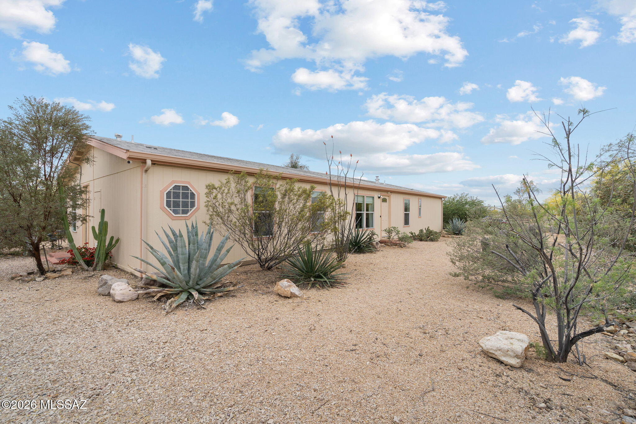 Welcome to this charming home in the Southwest area of Tucson, offering space, comfort, and flexibility on over an acre. This well-maintained 4-bedroom, 3-bath home features a versatile layout, including two bedrooms connected by a Jack and Jill bathroom, plus an additional room ideal for an office or storage. Enjoy an open layout, updated flooring, and a functional kitchen with included appliances. The spacious covered patio is perfect for relaxing or entertaining, while the property offers mature desert landscaping, fruit trees, two sheds, and no HOA allowing for room for toys, animals, or future expansion.