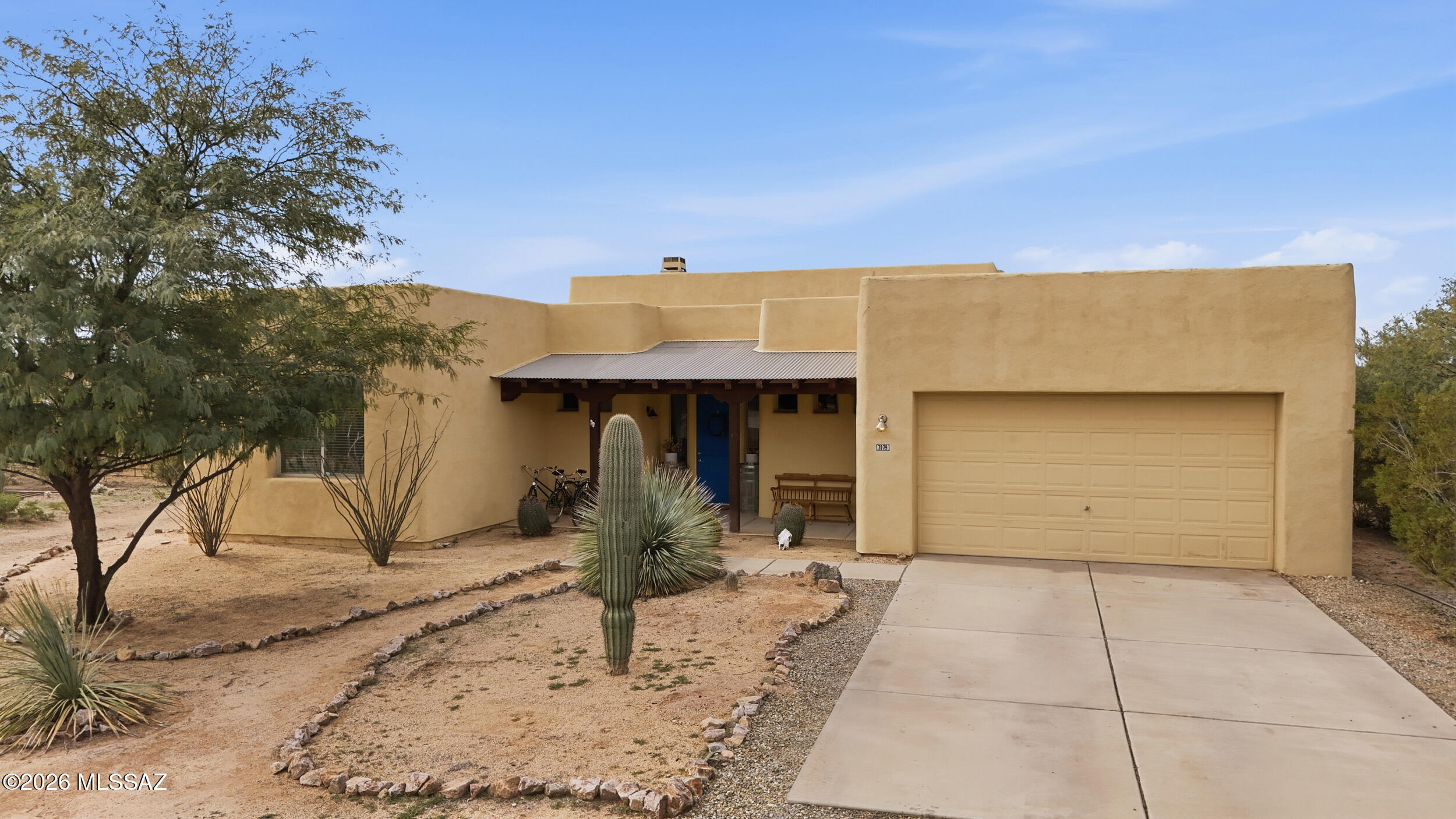Beautiful Santa Fe-style home on a full acre with natural desert landscaping and breathtaking mountain, desert, and sunset views! Spacious split floor plan features a large primary suite with en-suite bath, soaking tub, and oversized walk-in closet with custom features. Enjoy vaulted ceilings, abundant natural light, and a cozy beehive fireplace in the great room. Chef's kitchen offers stainless steel appliances, open layout, and pantry. Includes a den plus bonus office space off the kitchen. Relax on the oversized covered patio and enjoy plenty of room to create your desert oasis and animal pens.