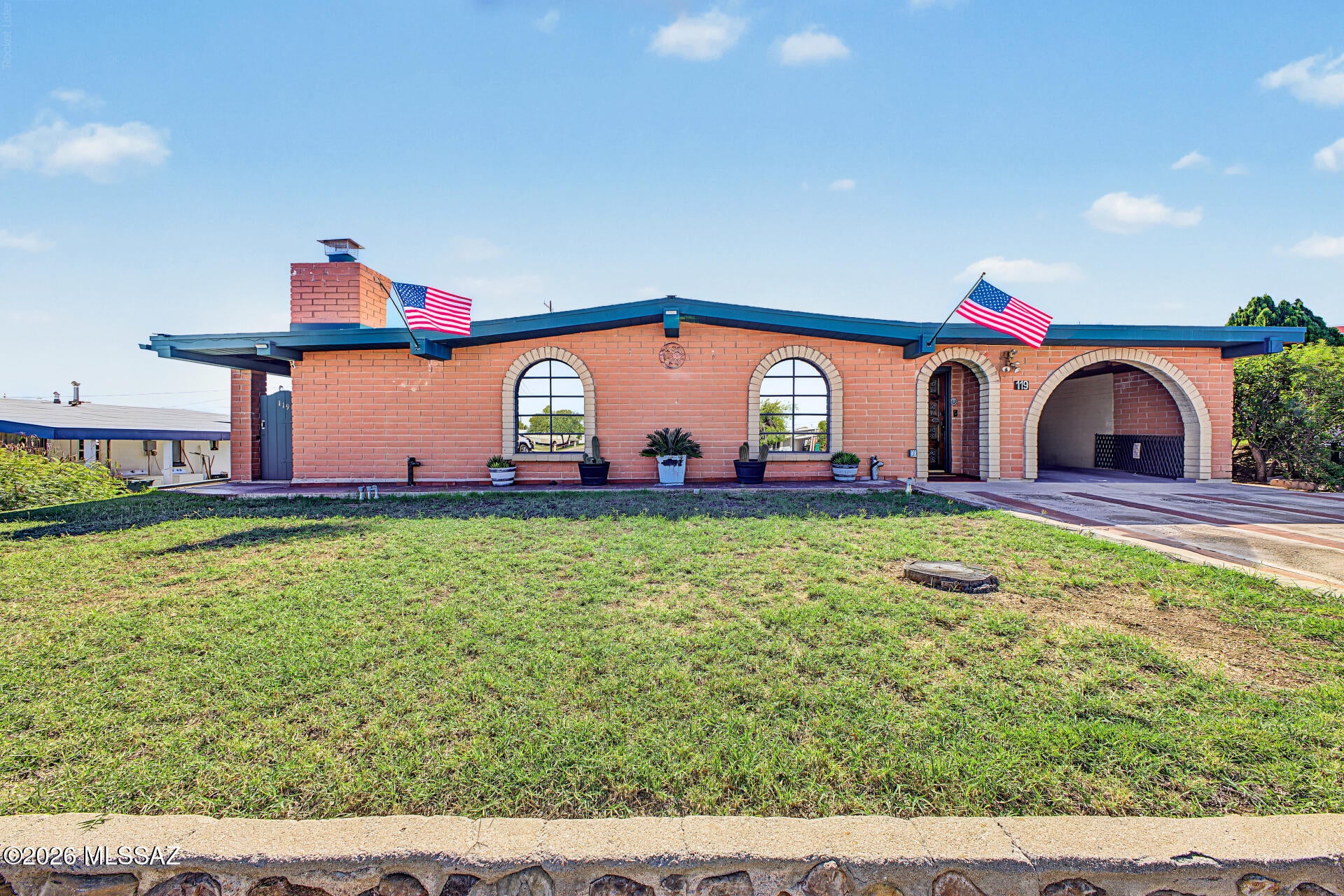 Rich in character and craftsmanship, this custom-built slump block home in historic San Manuel is a showcase of custom masonry, woodwork and rustic charm. Lovingly cared for by just two owners, the 3-bedroom, 1,990 sq. ft. home features soaring vaulted ceilings, exposed wood beams, intricate brickwork, custom stone finishes and a striking brick fireplace at the heart of the living space. The spacious primary suite offers vaulted wood ceilings, a generous walk-in closet and private outdoor access. Additional highlights include a relaxing spa tub, versatile Arizona room and detached 2-car garage with workshop potential. Outside, handcrafted masonry walls frame private yards, garden beds, a built-in BBQ and mountain views. A truly unique home with attention to detail rarely found today!