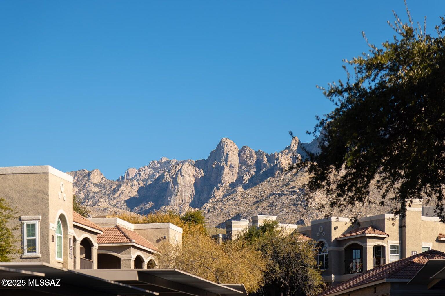The most affordable unit in the community! Enjoy luxury living at a bargain price. This fully remodeled GROUND FLOOR condo is in a community w/ all of the extras. New HVAC 2020, new windows 2019. The location is breathtakingly beautiful, nestled at the base of the Catalina Mountains. This home has tile & engineered hardwood floors; you'll love the remodeled kitchen with new cabinetry, granite counter tops, and SS appliances; there's a full-size bathroom with custom travertine shower surrounds and vanity top and full-size laundry closet; the home has a spacious floor plan with an amazing patio; the bedroom is enormous with a huge walk-in closet to match. HOA inc.: heated pool/spa, biz. center with conference area, clubhouse, fully equipped fitness & weight room, bbq area, & water inc.!