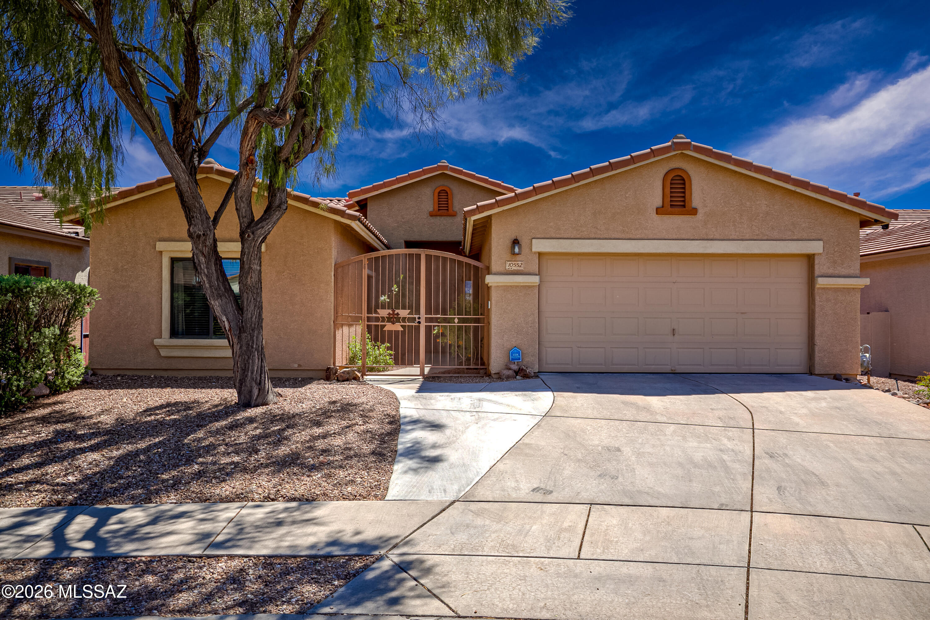 Located in desirable Mesquite Ranch, this move-in ready 4-bedroom, 2-bath home offers comfort, style, and privacy in a quiet neighborhood with true Southern Arizona charm. The gourmet kitchen features a huge island and a bright breakfast nook with bay windows, perfect for everyday living and entertaining. The den has a Murphy Bed and could be converted to a 5th bedroom or office. A split bedroom floorplan provides added privacy, while the beautiful courtyard with a wrought iron security gate creates a warm welcome. Enjoy an extended 3-car garage, owner-owned solar, and a water softener. With no neighbors behind--just natural desert--relax in a serene setting. Conveniently located near shopping, Davis-Monthan Air Force Base, and in the top-rated Vail School District. A must-see!