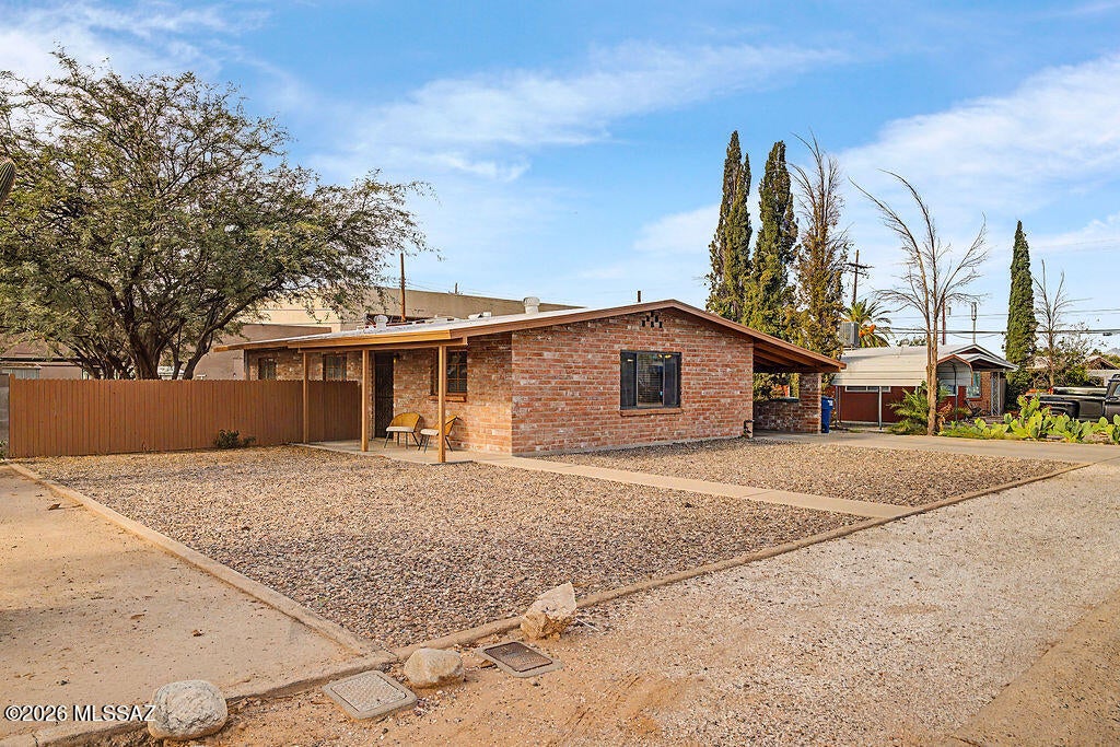 Seller is offer 5k seller concessions, and just adjusted the price. Use  the 5k to buy down the interest rate , add a better backyard fence or do closing costs.  Absolutely awesome house that your parents would approve.  Adobe 3br/2bth with huge kitchen and backyard.  Knotty pine cabinets add charm as do the retro green and maroon bathrooms tiles.  This is so  ''NOT COOKIE CUTTER '' Great light, north south exposure.  Dead end street, covered carport with more parking access from an alley gate..  Roof recoated in 2026 and new HVAC in 2024. There is nothing to do the main areas of the house have a neutral newer tile and the bedrooms have brand new carpet.  Don't pass this house by , it is truly worth seeing.  This house is so special and absolutely ready for you to see and fall in love.