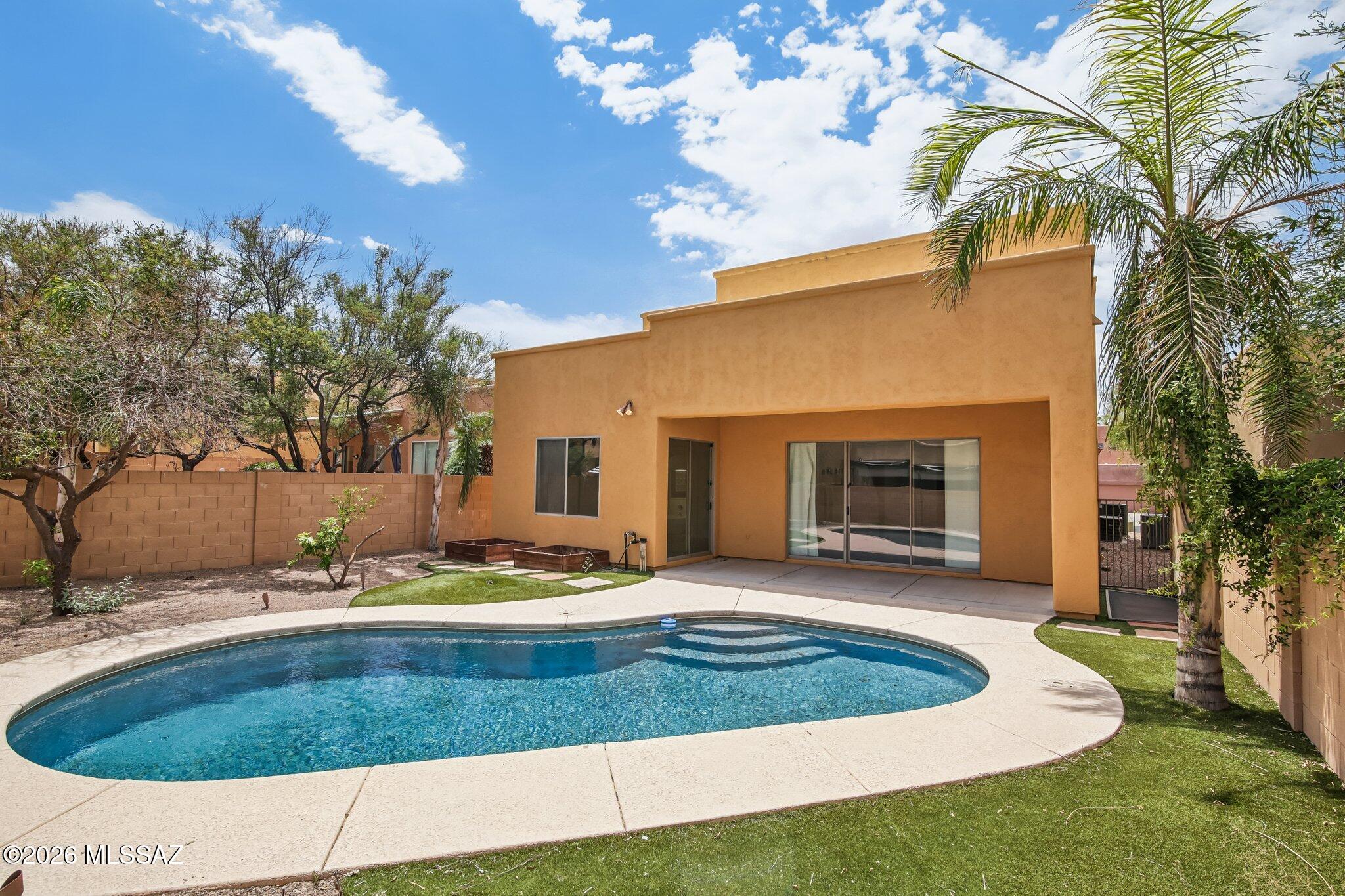 Welcome to this stunning 5-bedroom retreat in the gated community of Red Adobe Pass. From the moment you enter, soaring vaulted ceilings and an open, light-filled layout set the tone for effortless living and entertaining. A serene, well-designed floor plan flows naturally from room to room, offering both openness and privacy in equal measure.
Outside, your private backyard oasis awaits: a sparkling pool with a new pump and filter (2025) and a covered patio perfect for year-round Arizona days. Solar panels keep energy costs low while you enjoy the sunshine that makes this location so special.
Inside, the home impresses with 3 full baths, a versatile loft, fresh interior paint, durable concrete flooring, and a cozy gas fireplace. The kitchen shines with stainless steel appliances, a breakfast bar, and a brand-new LG refrigerator. The main-level primary suite offers dual vanities, a soaking tub, a walk-in closet, and direct backyard access. Two more bedrooms and a full bath sit downstairs, while upstairs adds two additional bedrooms, a full bath, and that flexible loft space.
Ideally set in Northeast Tucson near Mount Lemmon, Sabino Canyon, Catalina Highway, Redington Pass, golf courses, shopping, and dining -- this home puts nature and convenience within easy reach.