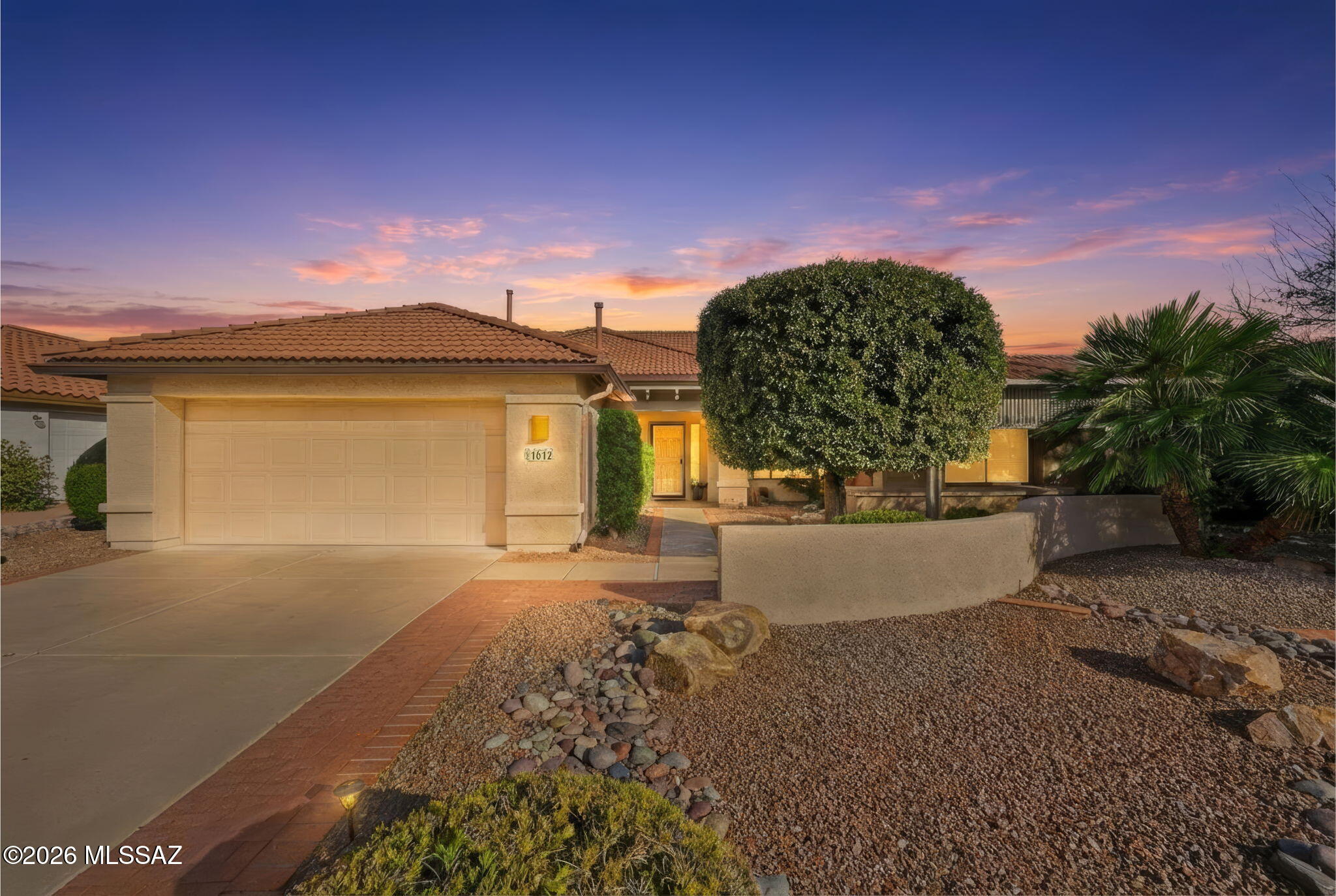 This gorgeous and spacious Montana floorplan home in the resort community of Quail Creek has been meticulously maintained, offering true peace of mind and years of worry-free living. Major updates have already been taken care of for you, including a new roof installed in June 2023 with double underlayment that remains under warranty, two new HVAC systems replaced in November 2022 with 10-year warranties, and a new 50-gallon hot water heater installed in October 2024 to ensure long, relaxing showers. Around 2019, the irrigation system was fully upgraded to durable PVC piping—far superior to standard tubing—and was completely inspected and renewed again in March 2025. As you arrive, lush vegetation and mature landscaping immediately showcase the home's exceptional curb appeal. The two-ca garage offers protection for your vehicles along with built-in cabinetry for abundant storage. Inside, warmth and comfort greet you with a spacious living room featuring vaulted ceilings and expansive windows that flood the space with natural light, allowing you flexibility in arranging your furnishings to suit your lifestyle. Two dining areas provide versatility, use one as a casual breakfast nook and the other for more formal gatherings, both conveniently located near the generously sized kitchen. The kitchen offers plentiful cabinetry, expansive counter space, and a large pantry closet ready to accommodate even the biggest warehouse shopping trips while keeping everything organized and within reach. Just off the kitchen, the laundry room and direct garage access make unloading groceries effortless. A dedicated office/den provides flexible space to customize for work, hobbies, or additional guest accommodations. The spacious primary suite is filled with natural light and features an en-suite bathroom with dual vanities topped in cultured marble, a walk-in shower, and a custom closet system designed for maximum organization. The guest bedroom is a standout, featuring a beautifully crafted built-in wood bed with surrounding cabinetry, along with an integrated desk system so the room functions seamlessly whether hosting guests or serving everyday needs. Step outside to your private backyard retreat where a covered patio has been extended with an aluminum wood-look pergola, creating additional shaded living space over brick pavers that provide both beauty and a smooth walking surface. Mature trees and thoughtfully placed plantings create your own Arizona oasis, while decorative rock landscaping keeps maintenance minimal so you can spend more time enjoying the resort lifestyle this community offers. Perfectly positioned in a cul-de-sac location, this exceptional home combines quality, comfort, and lifestyle, it is one you will not want to miss.