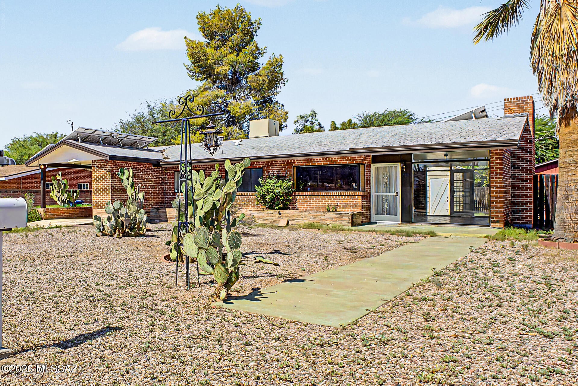 Welcome to this adorable single-story home! This gem boasts an inviting curb appeal, mature landscaping, and convenient carport parking. Inside, you'll find sizable living areas ready to bring you joy. Window walls provide abundant natural light in every space. Wood-look paneling adds character, complemented by Saltillo Terracotta Tile flooring. A brick fireplace is perfect for chilly evenings. The kitchen comes equipped with flat-panel cabinetry, tile backsplash, tiled countertops, a breakfast bar, and a breakfast nook. Relax after a long day in the carpeted main bedroom, which offers a full bathroom for added comfort. The backyard features ample space for outdoor activities, complete w/ a storage shed for added organization. Owned solar panels with no lease or loan to assume! Agent/owner