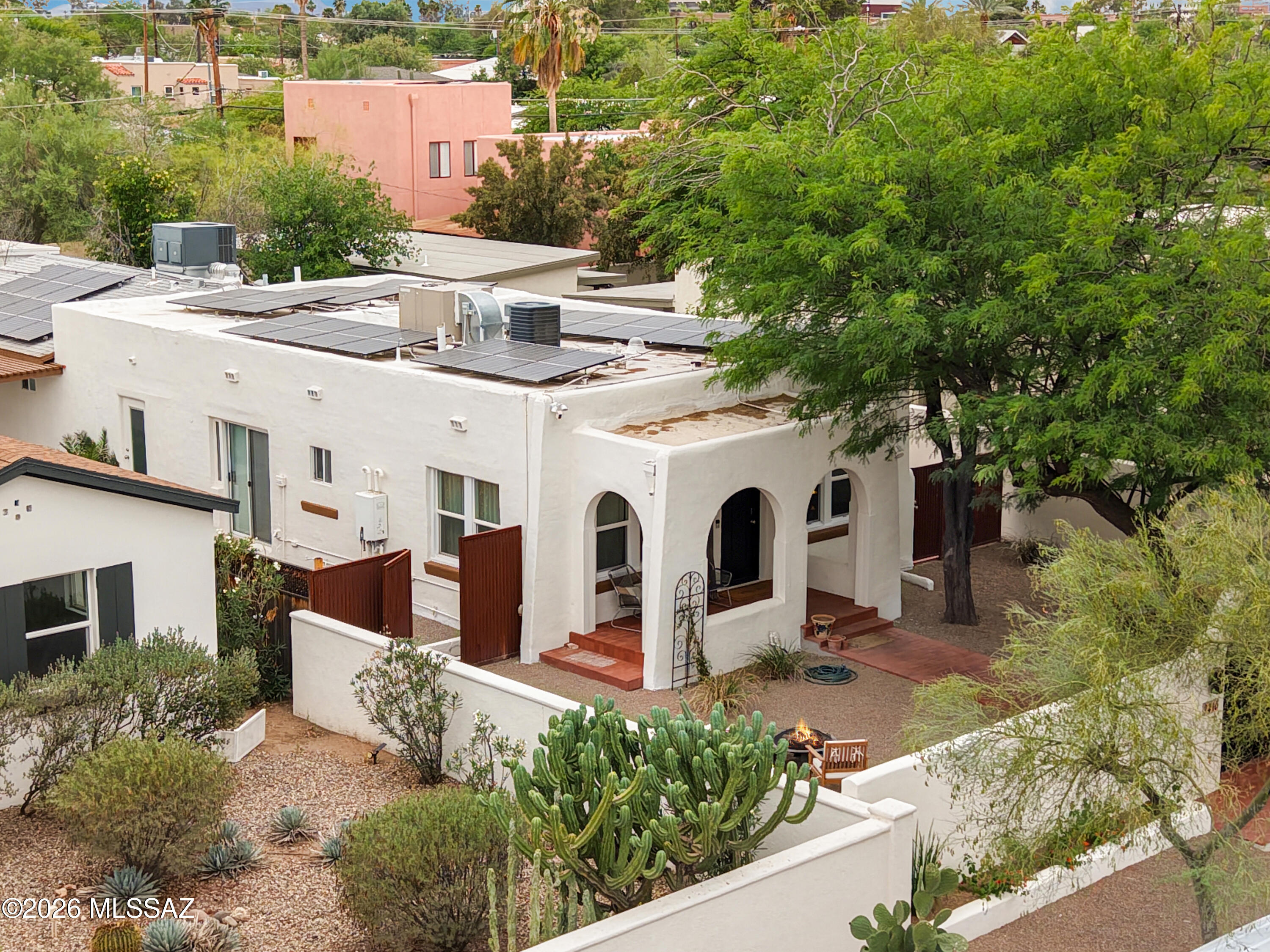 Gorgeous remodeled Blenman home you won't want to miss.  Absolutely move in ready, the kitchen and baths are remodeled, yet the home retains the cozy charm of 1933.  OWNED SOLAR with 33 panels & 2 TESLA backup batteries. This is a family-sized property: main house has 4 bedrooms and 3 full baths, with private gated walled front yard and side patios. The separate guest house has a full bath and full kitchen, and a private entrance and patio of its own, should one want to Airbnb or rent. Current owners used it only for family. There is offstreet parking in back, from the alley, for both the main house and GH. The GH yard has space for a pool too! To see this property is to want to make it home. Proximity to UA, Banner, Himmel Park, downtown... it's a dream and a ''biker's paradise'' score 98