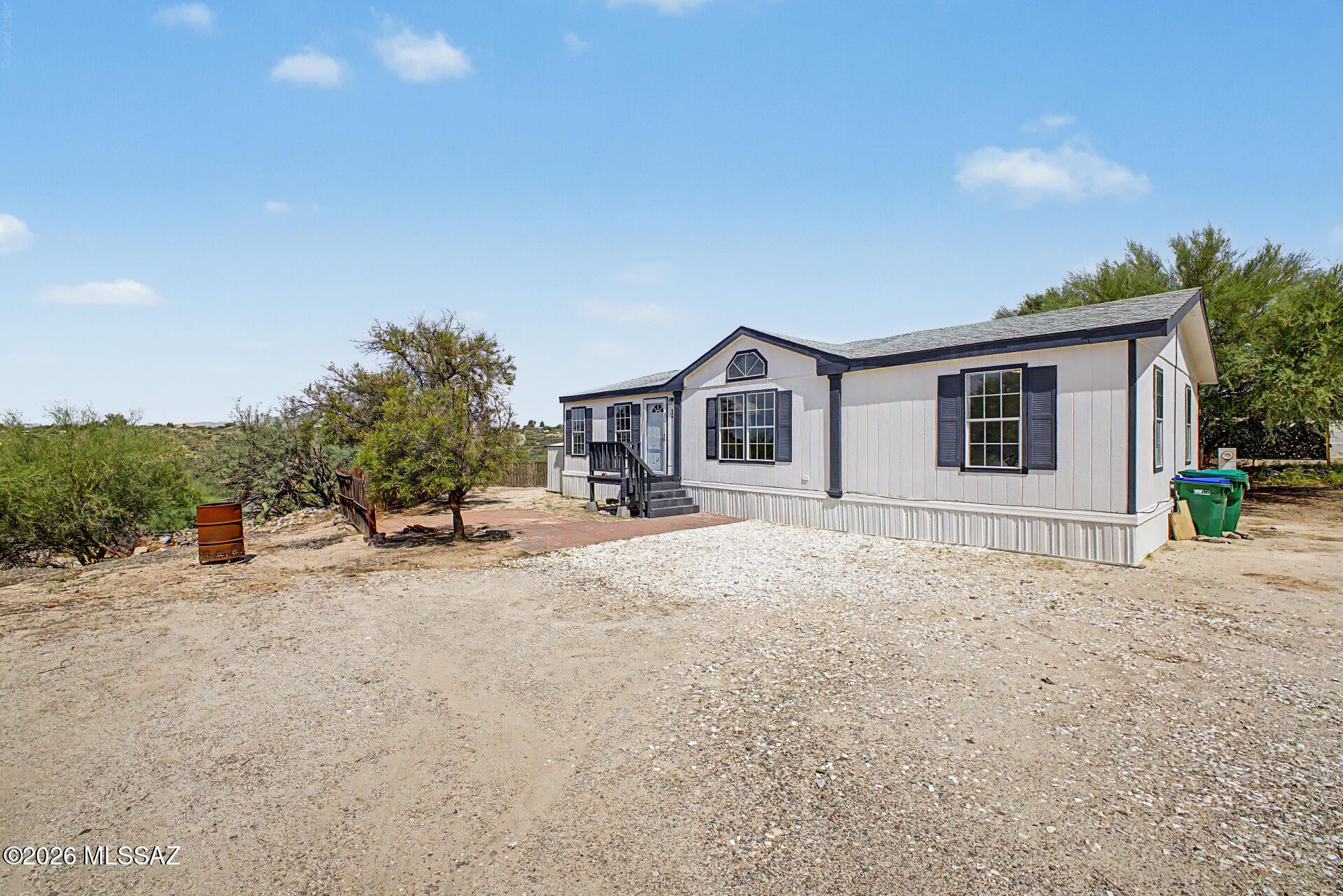 Catalina living, wide open -- Nearly ¾ acre with room to roam, zoned Pima County GR-1, no HOA. Perched above the Canyon Del Oro Wash with the Santa Catalina Mountains' western slope as your backdrop, this well-kept 1996 manufactured home delivers an open-concept floor plan with a split-bedroom layout for real privacy -- 3 beds, 2 baths, 1,344 sq ft. Bring the RV, bring the boots -- trailheads are practically out your back door. Minutes from shopping, dining, and medical, with Northwest Tucson living at a price that still makes sense. This kind of land, this close to the mountains, won't last -- schedule your showing today.