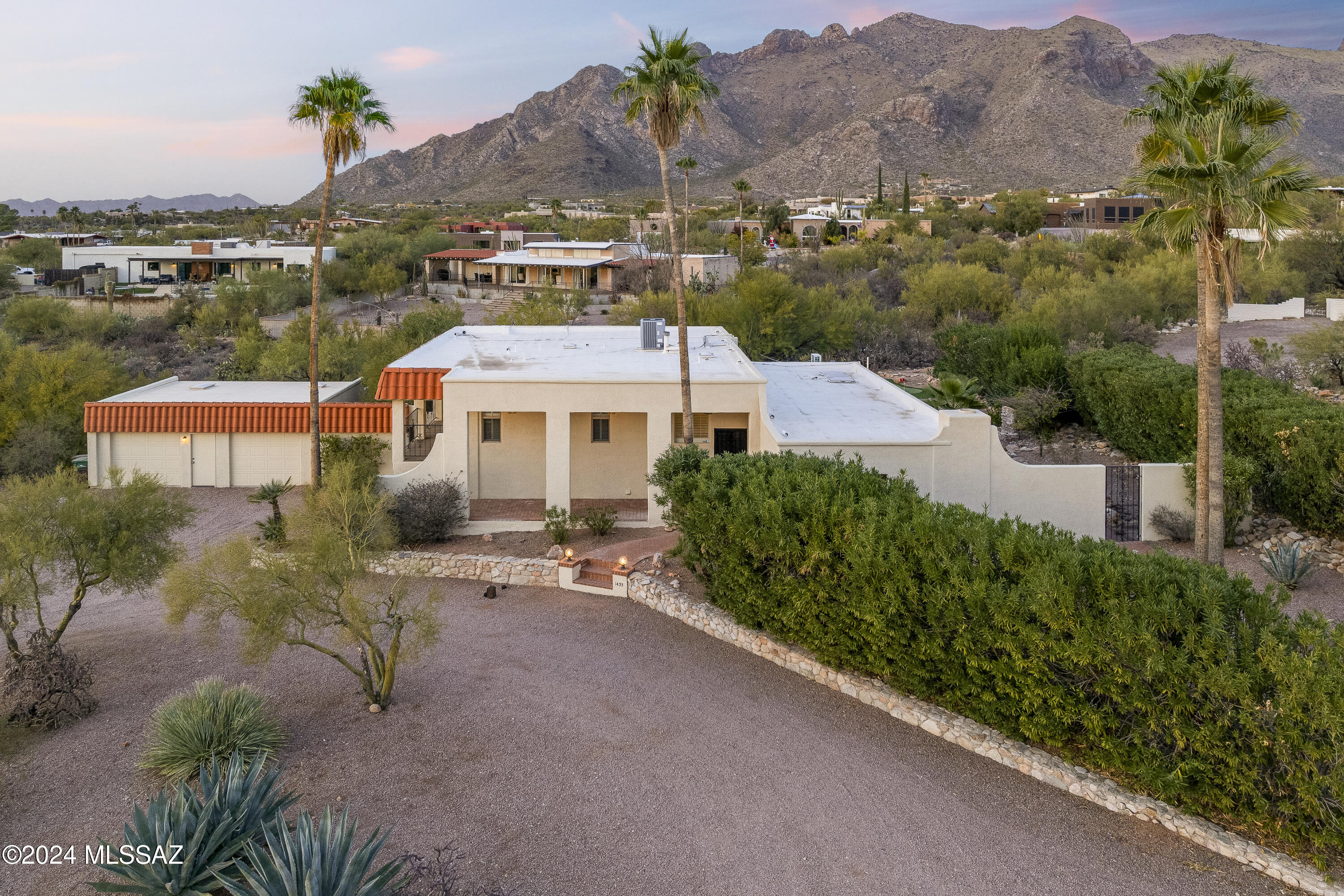 This 4-bedroom home captures stunning mountain and city views from multiple vantage points. Features include an updated kitchen and beautifully updated bathrooms, new interior and exterior paint and brand-new carpet throughout. An airy sunroom off the kitchen is filled with natural light and perfectly frames the mountain backdrop. Spacious bedrooms offer comfort and flexibility, the downstairs suite includes its own living area, bathroom, and private entry--ideal for multi-generational living or a college student. Enjoy sunsets from the full-length deck off the primary and second bedrooms. The multi-level backyard boasts a putting green, outdoor fireplace with seating area, and a multi-tier shade structure. Includes a 408 sqft heated and cooled detached garage--perfect for Shop or Gym.