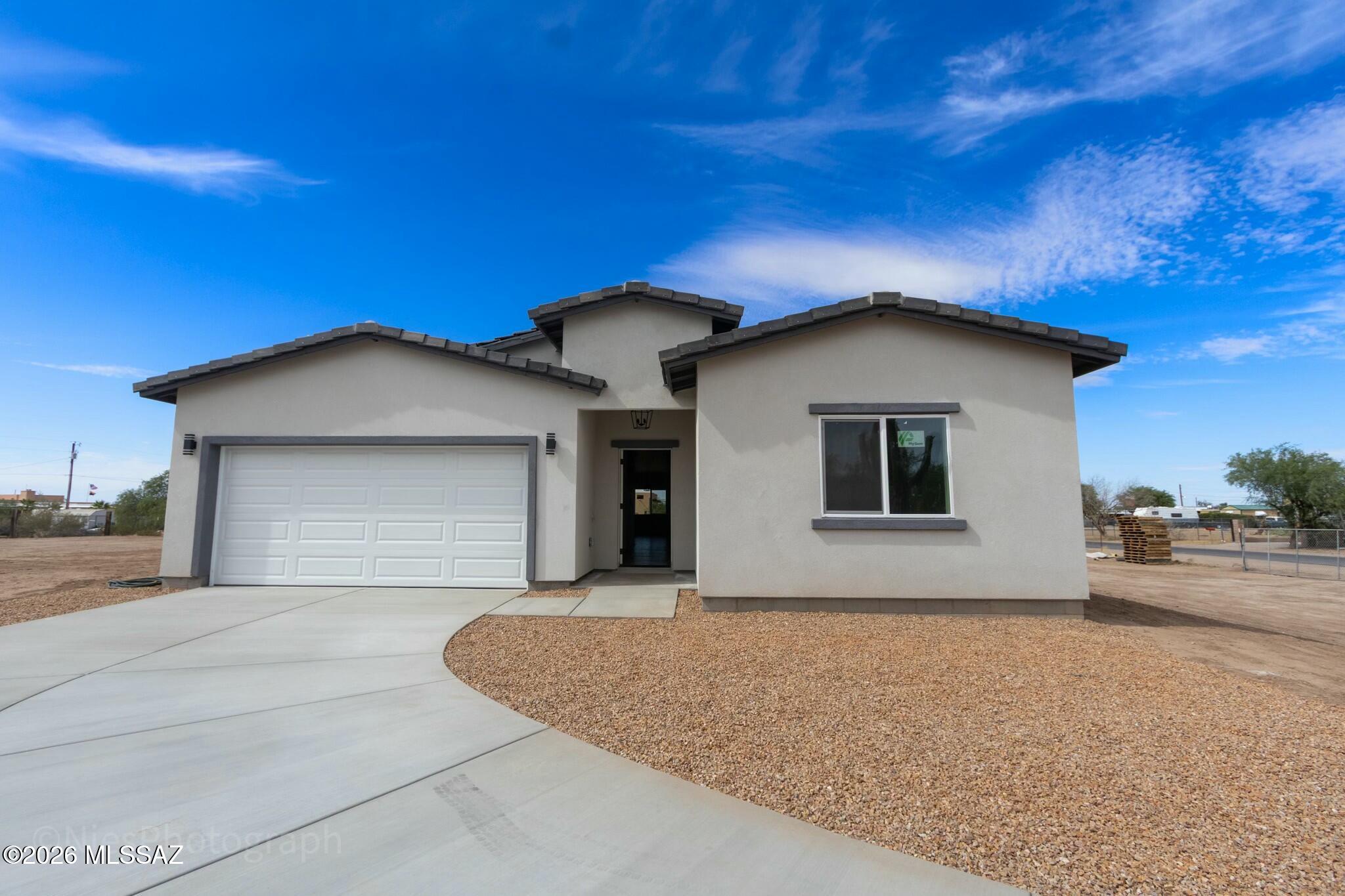 Move-in ready new construction on a full one-acre corner lot in a desirable Marana location with no HOA. This modern and elegant home features 4 bedrooms plus a dedicated office, 2.5 bathrooms, and a thoughtfully designed open layout with a clean contemporary style. Beautiful finishes, updated details, and quality craftsmanship throughout create a refined yet comfortable living space. The spacious lot offers privacy and flexibility, with room for horses, trailers, recreational vehicles, and more. Located on a fully paved road in a quiet area with room to breathe, yet conveniently close to town. This property qualifies for USDA financing, and the seller is offering concessions. Come see everything this beautiful home has to offer.