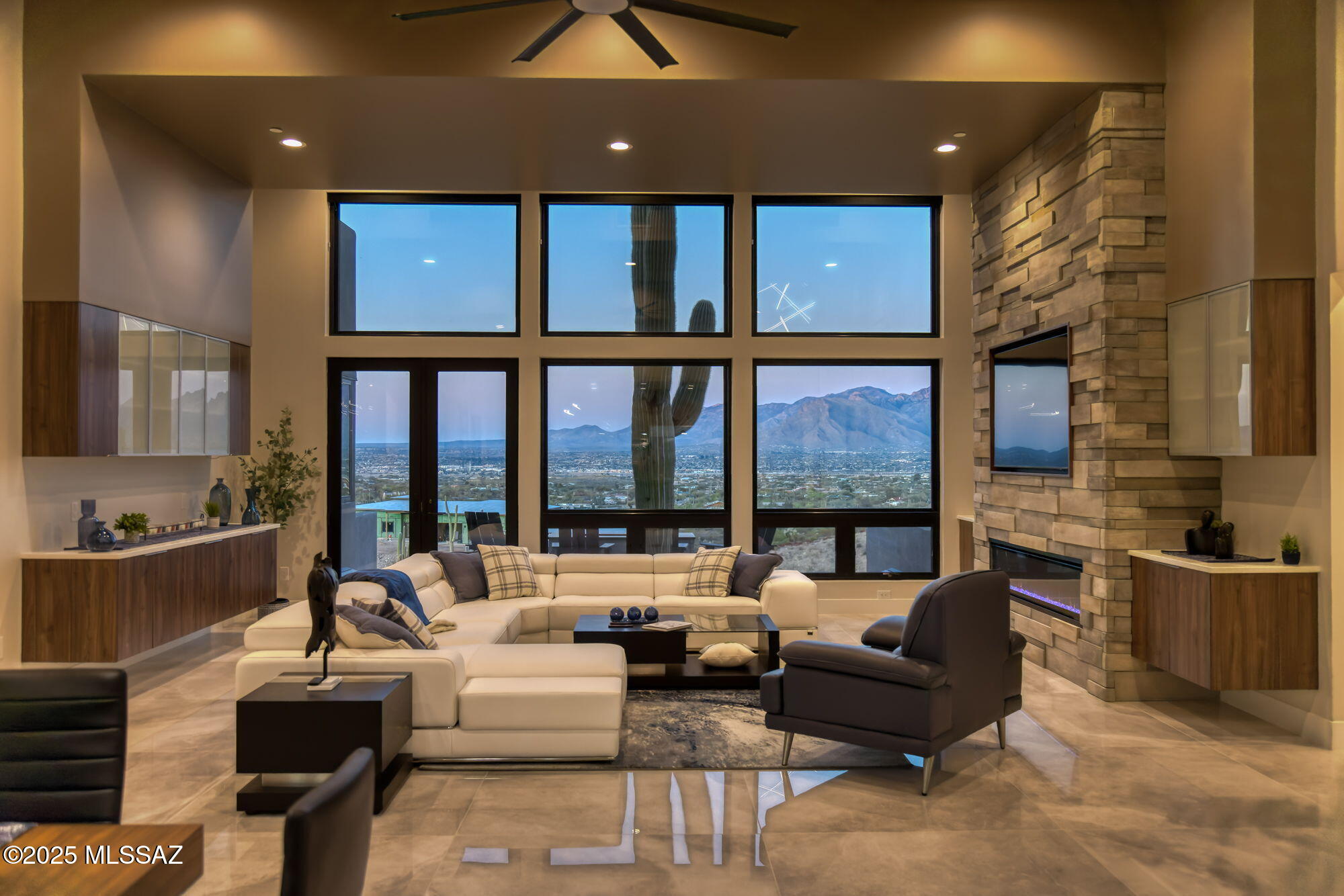 Seller is a Midwest Architect & Builder who specializes in designing and building high end homes. This property showcases his skills and workmanship. Perched in one of Tucson's most coveted gated communities, this stunning ultra-contemporary residence redefines year-round luxury living. A striking cantilevered porch entry and bold architectural lines introduce the home's meticulously curated design, setting the tone for the sweeping east-facing views of iconic mountain ranges and striking modern architecture that set this home apart. Set on a premium lot surrounded by towering saguaros, the home captures unending vistas—sunrises that awaken the mountains, city lights that twinkle at dusk, and sunsets that paint the sky with vibrant color. Thoughtfully designed, this custom home offers over 3,400 square feet of refined indoor living, featuring 4 bedrooms, polished marble flooring, and a show-stopping ceiling-to-floor stone fireplace with a modern linear gas fireplace. 
 
A gourmet kitchen and dining area provide the ideal space for unforgettable culinary experiences, inside, opulence meets functionality in the oversized commercial-grade equipped chef's kitchen adorned with top-of-the-line stainless steel appliances, a black leather island, a Sub-Zero refrigerator,  artisan tile, and lighting. 
 
The private primary suite is a retreat, complete with a modern linear gas fireplace, built in tv, freestanding soaking tub, black leather-accented double vanities, and cutting-edge glass and tile.  
 
The indoor-outdoor connection is unparalleled, with a 4 car garage, expansive deck, stone deck accented with steel featuring a built-in-BBQ, outdoor kitchen, spa, lap pool with a retractable pool cover, wood plank ceilings with fans, and modern tile work. and fire pit set up to create a true retreat for relaxing or entertaining.
 
This stunning custom residence embodies a statement of modern desert living, reimagined with style, vision, and timeless appeal.