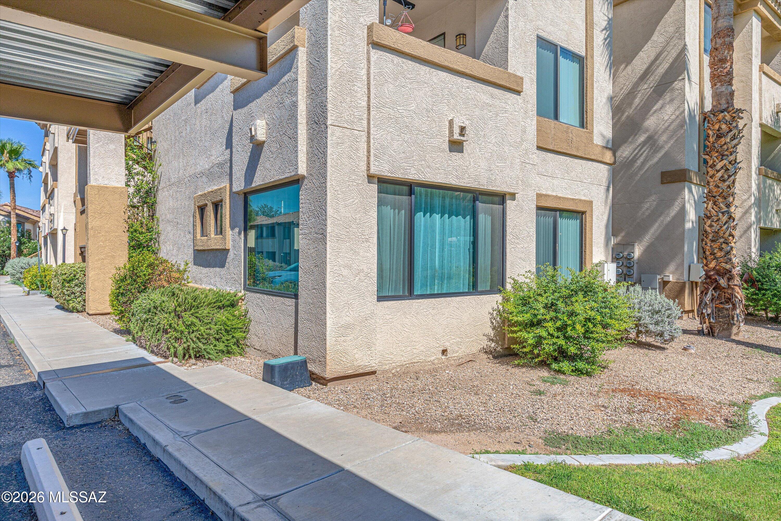 Welcome to easy, low-maintenance living in one of Tucson's most desirable locations! Short walk to groceries & St. Philip's Plaza, with a variety of restaurants, coffee shops, bakery treats, boutiques, fitness studios, Pilates & yoga classes. 
This bright & inviting first-floor corner condo is located within the gated Villas at Hacienda Del Sol, surrounded by mature trees & lush greenery. High ceilings & abundant natural light create an open, airy feel, with the additional approximately 200 sq. ft. enclosed Sun Room. Brand-new paint & carpet make this home move-in ready!
Community amenities including 2 sparkling pools, 2 spas, BBQ areas, a fitness center & a community center. Direct access to The Loop & River Walk for running & biking...[SEE MORE] Suitable for a full-time home, a lock-and-leave retreat, or a convenient place to enjoy an active Tucson lifestyle. This condo offers an exceptional combination of location, flexibility & lifestyle. Schedule your showing today and come experience it for yourself!