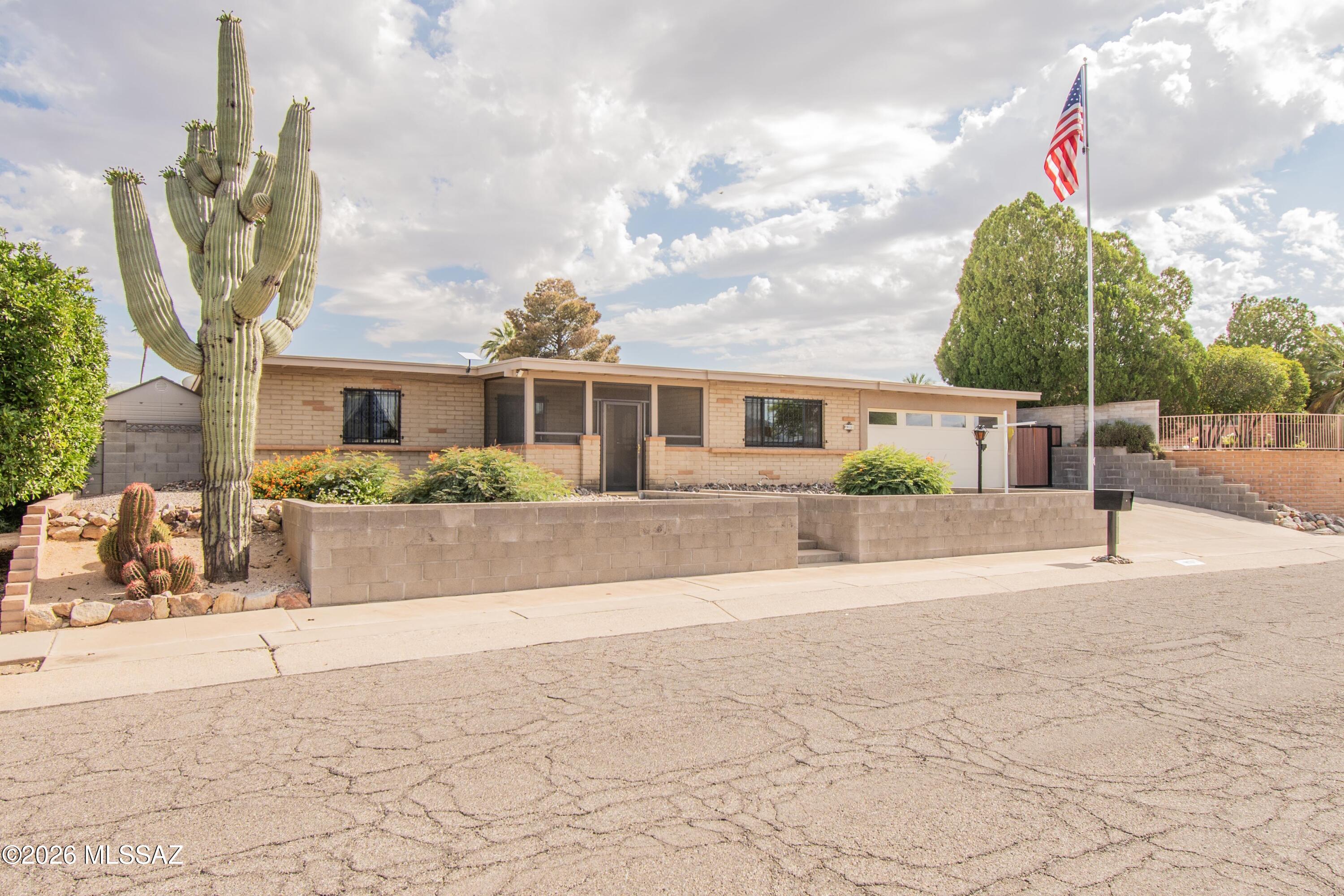 This is a rare find - well loved, thoughtfully upgraded, and offering inviting outdoor living. You've hit the trifecta you've been looking for! A great blend of character and modern comfort in this 3-bedroom 2 bath home cared for by the same owner for 46 years. Features include an oversized garage, HVAC and tankless water heater installed in 2025, 2 screened porches, a crystal-clear pool, 2 pergolas, and even the Traeger BBQ grill out back stays! Enjoy a stunning kitchen with an oversized granite island, integrated refrigerator, gas range and cozy beehive fireplace. Laundry room has tons of extra storage and pantry space. HOA is only $30 a YEAR. Meticulously maintained, this this not your typical 70's block home.