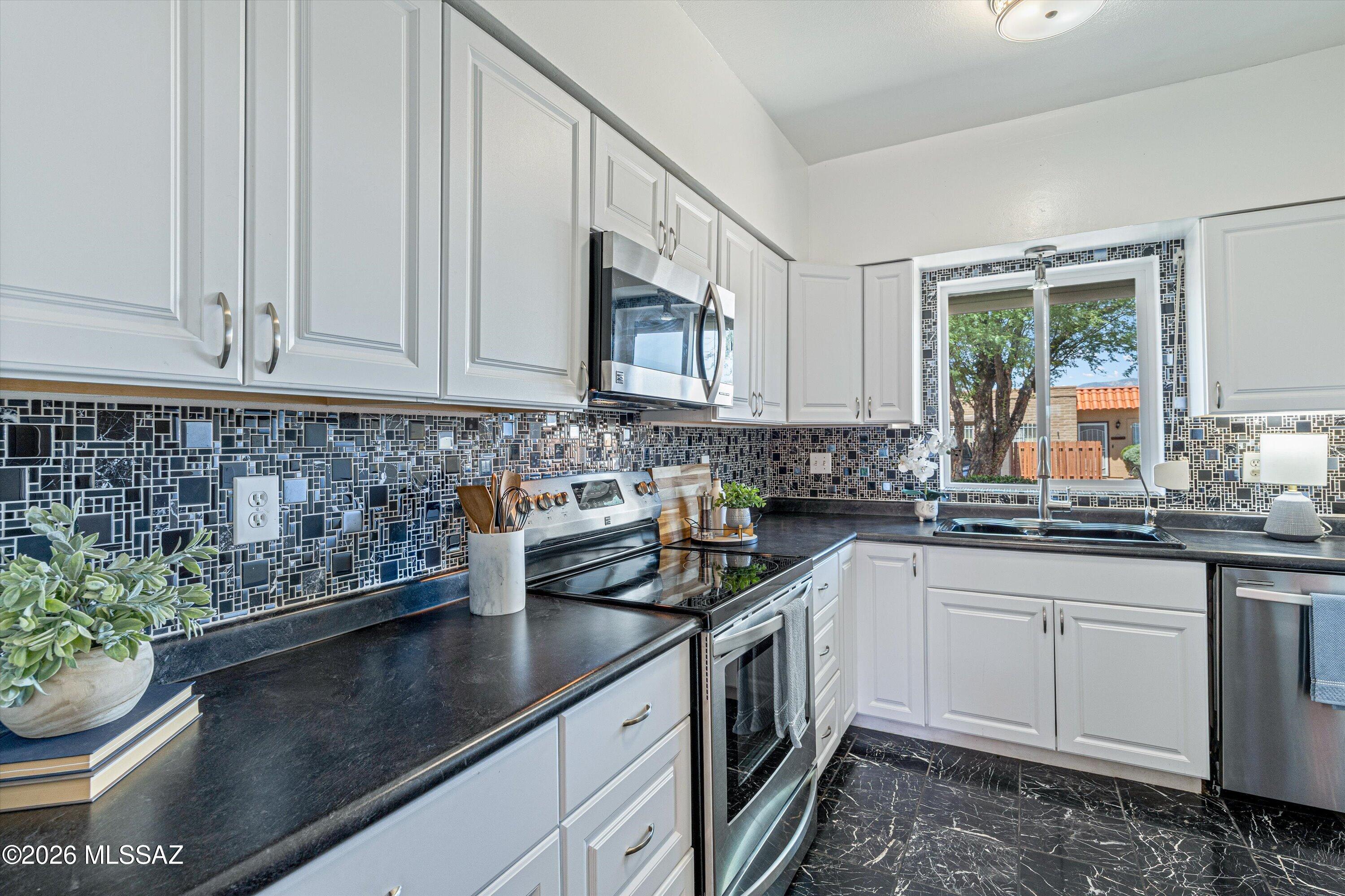 Located at the back of the subdivision on a desirable corner lot that offers privacy and easy access to the Loop walking and cycling path.  This updated 3-bedroom, 2-bath townhome has an updated kitchen that features stainless steel appliances and a lovely mountain view from the window. The spacious primary suite includes double closets, a patio slider, and an upgraded ensuite bath with a step-in tiled shower. The updated guest bath features a relaxing jetted tub. Luxury vinyl plank flooring flows throughout the living spaces and bedrooms for a clean, modern look. Enjoy the convenience of low-maintenance living with a desirable location close to shopping and restaurants.
