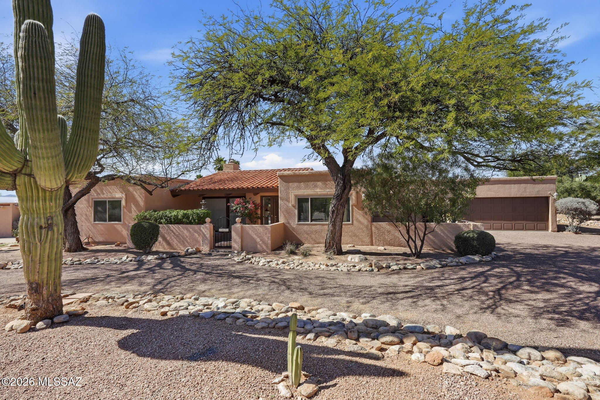 Tucked into a private setting in the desirable Shadow Hills neighborhood, this home offers the perfect blend of character, comfort, and stunning natural surroundings.  Walls of windows flood the home with natural light, highlighting the timeless charm of Saltillo tile floors, a beamed vaulted ceiling, and a cozy wood-burning fireplace. The thoughtfully designed layout features zoned HVAC and newer sliding glass doors that seamlessly connect indoor and outdoor living.  Recent updates include a brand-new roof and freshly painted interior. Step outside to a sparkling swimming pool, mountain views, view fencing, and open space with natural desert behind, creating a serene backdrop you'll enjoy every day. A rare opportunity to own a character-filled home with privacy, views, and modern updates.