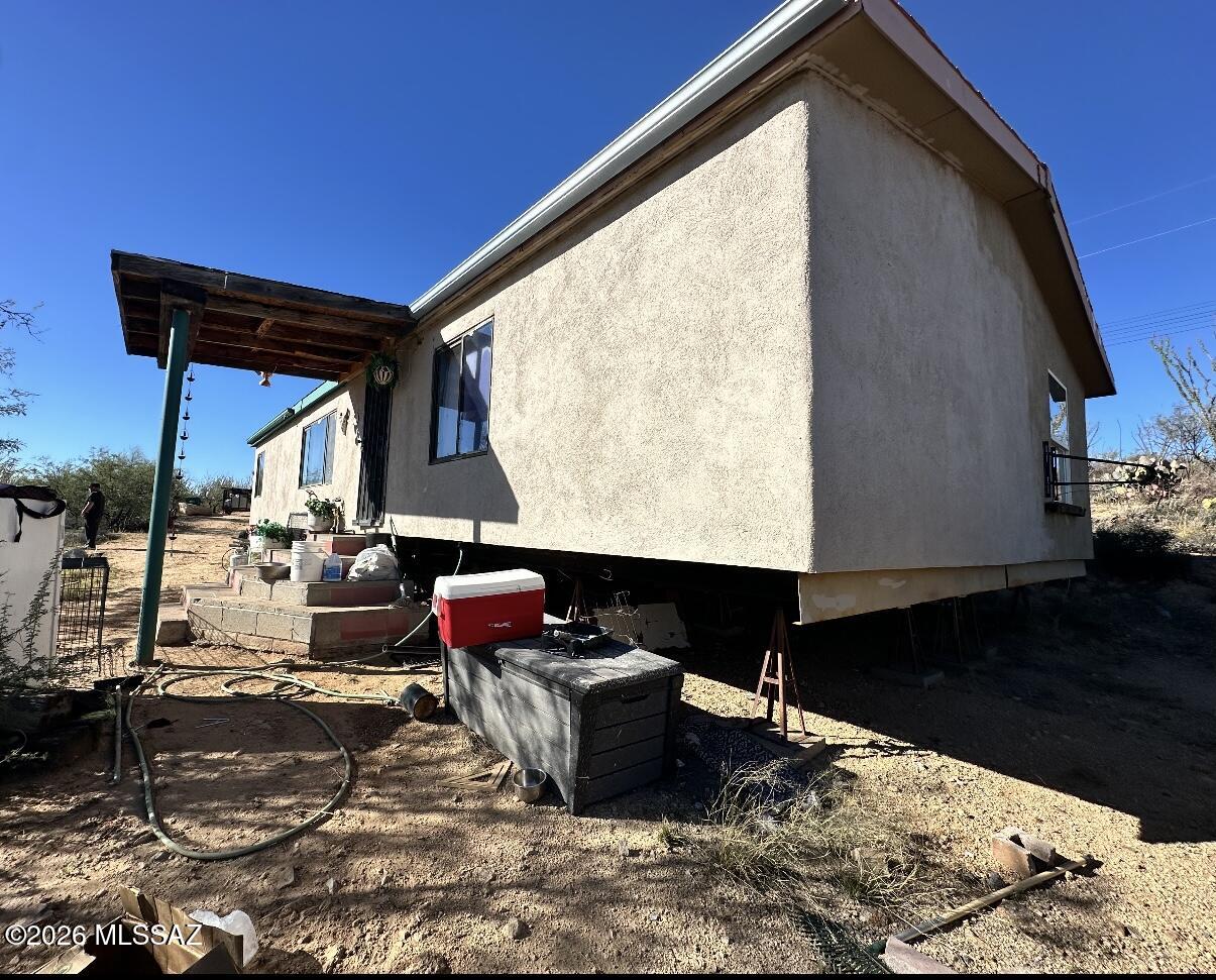 Deeply Discounted Investor Opportunity on 4.94 Acres in Sahuarita! Rare chance to secure a discounted property with major upside. 3 bed, 2 bath manufactured home (1,492 sqft) with existing utilities, septic, and hauled water. Features include mini-split system and tankless water heater. Home needs full renovation- ideal for fix & flip, rental, or land hold strategy. Private setting with wide-open desert views and no HOA. Cash or private financing only. Sold as-is. Strong value-add potential with room to expand, improve, or reposition. Don't miss this high-equity opportunity in a growing area.
Significant upside with rehab.