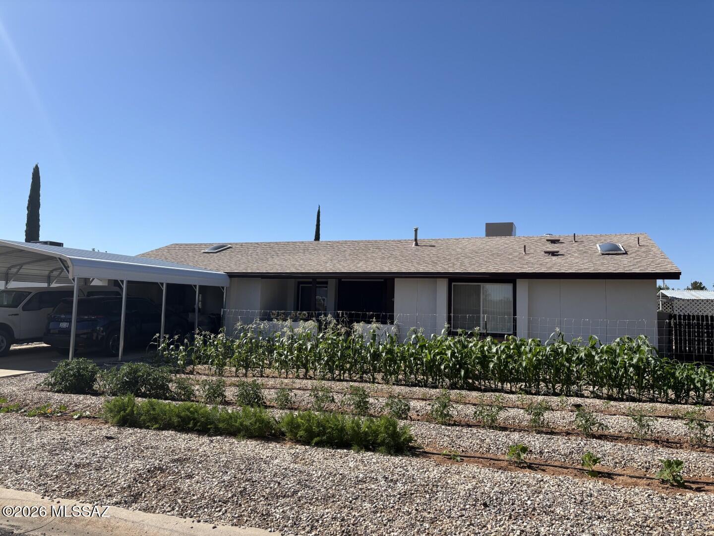 Gardeners dream home. Light and Bright with Vaulted LR ceilings. Bonus Rooms= double Den with office. Designated dining room. Screened in porch. BBQ area. Storage shed. 2 car garage with storage and work bench plus double carport. Property has lots of fruit trees. 3 Peach Trees, 2 Apricot, 1 nectarine, 1 Plum, 1 Cherry trees, 2 Apple Trees, 3 pomegranate, A whole fence line of seedless table grapes, Asparagus, Loads of Raspberries along the back fence, Strawberry patches, and you wont believe the size of the high producing black berry bushes along the East property boundary.  Vegetable gardens on the  front and side yards. all on auto drip irrigation. Come and enjoy a little bit of in town homesteading! Roof and Water heater replaced in 2022.