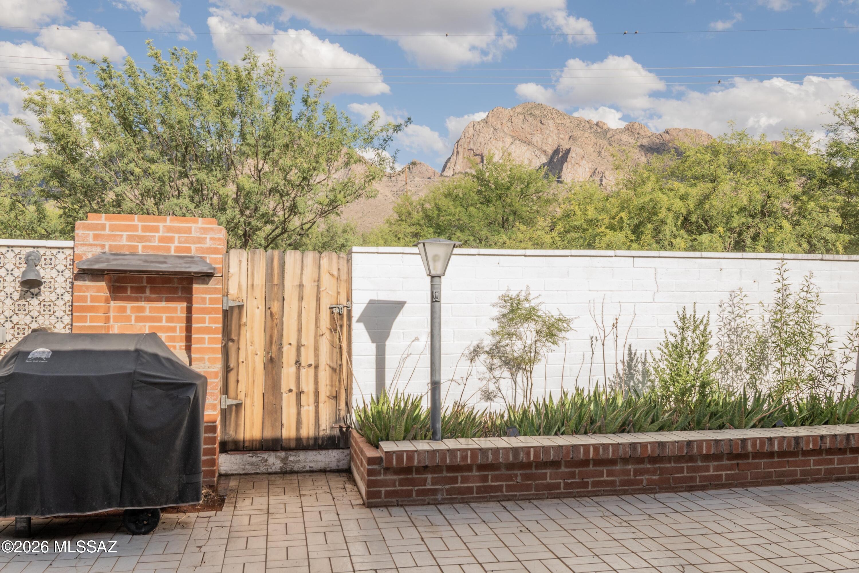 Views, location, and easy one-story living -- this Oro Valley townhouse has all three.  PLUS it's turnkey. 

Enjoy Oro Valley living with views of Pusch Ridge and the Catalina Mountains from this well-maintained one-story townhouse. This spacious 2-bedroom, 2-bath home offers solid masonry construction, a larger living area with beehive fireplace & rigid vinyl wood flooring.  Kitchen with casual dining space. Roof replaced in 2024.  No pop-corn ceilings. The east-facing back patio has no neighbors directly behind, flower beds, drip system, and beautiful mountain views. Located next to non-heated year-round pool, with the clubhouse & heated poo lnearby. Two-car carport. Adjacent to Oro Valley Country Club. Convenient to shopping, dining, entertainment, hiking, and The Chuck Huckelberry Lo What does NOT convey:  three off white recliners in Living room, the small wooden end table between the recliners, and the two bicycles in the storage unit. Of course all personal items do not convey.
