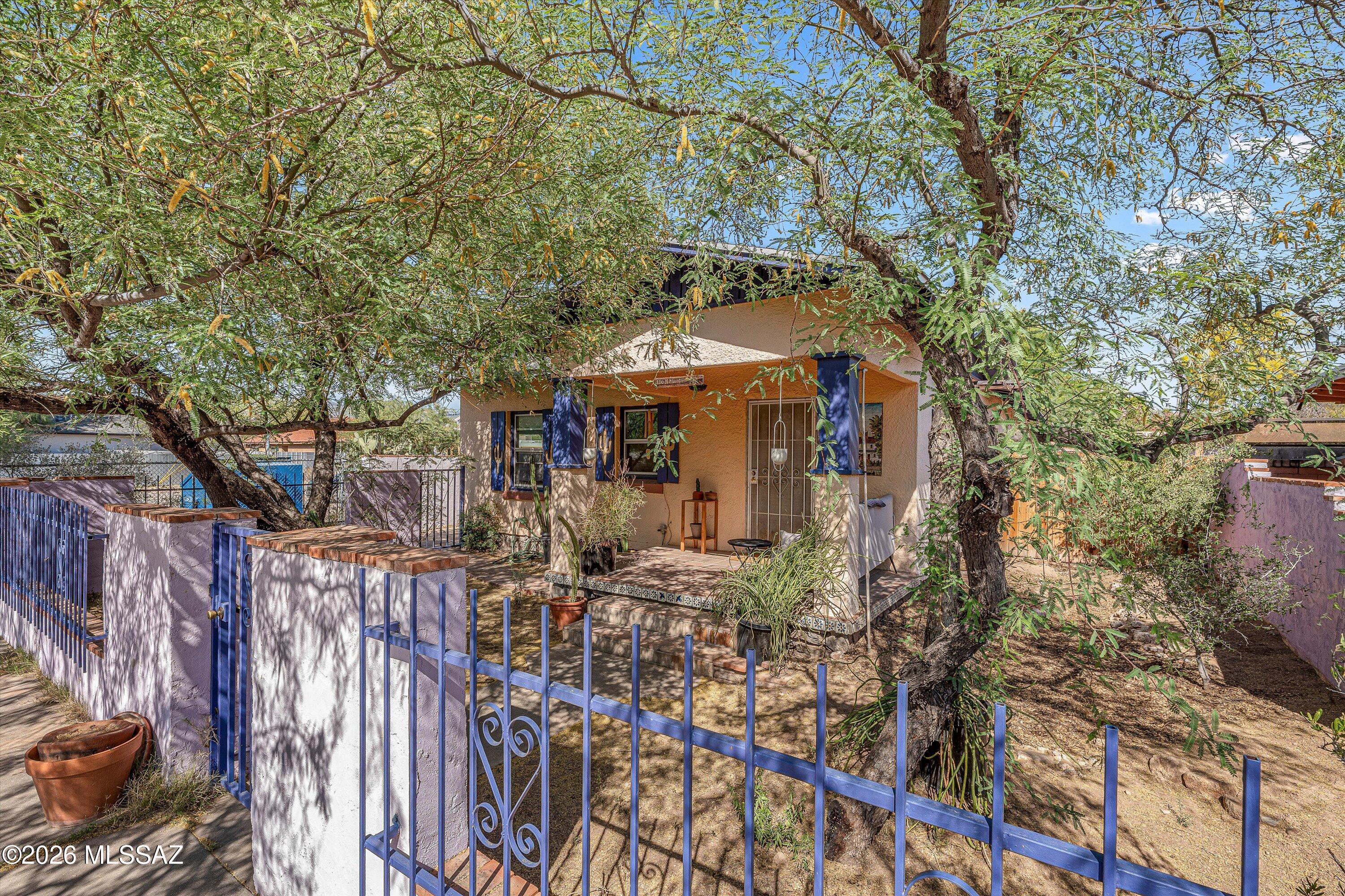 Charming 1930s Bungalo in the History Rincon Heights district blending vintage character with modern efficiency. This 3 bed, 2 bath home features tile flooring throughout, bold designer colors, and warm neutral wood accents. The functional kitchen anchors the central living space, while 2 of the 3 bedrooms offer private exterior entrances-ideal for flexible living or dual rental potential. Energy efficient updates include dual pane windows, insulated attic, front yard rain water collection landscaping, new roof '25, owned solar system, & tankless water heater for reduced utility costs. Located in a highly desirable historic neighborhood, a little over a mile to the U of A,  central to everything that the heart of Tucson has to offer. Come and tour this beautiful home and fall in love.