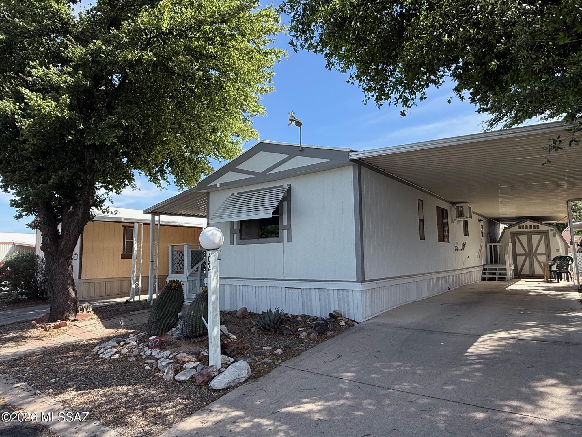 Cozy 2 bedroom 2 bathroom Manufactured Home located in the San Pedro RV Resort Community off Hwy 80 in Benson AZ. This home has a large covered deck for outdoor entertainment, storage shed, partial chain link fenced yard and a large shade tree to enjoy the outdoors on a sunny afternoon. The community amenities include an enclosed pool and hot tub, outdoor pool, clubhouse where there is often live music and entertainment, dog park, pickleball court, bocce ball, horseshoes and more The house has been recently painted inside and out and partially renovated waiting for a new owner to make it their own. The purchase includes the home only. The lot is leased.