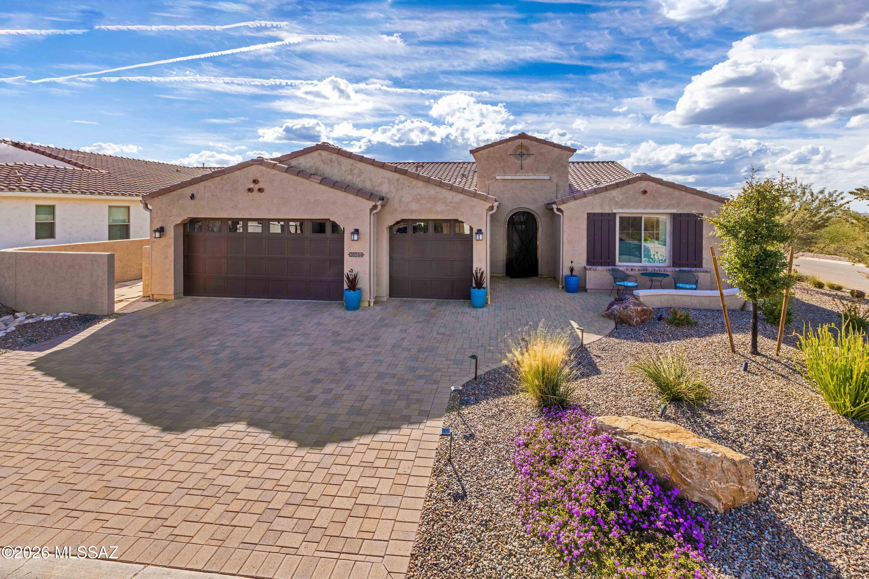 Stunning 2021 upgraded Vienta with soaring 11' ceilings & panoramic views. Gourmet kitchen features custom cabinetry, GE Profile appliances & wine fridge. Spa-like primary bath with curbless shower & rain glass. Extended 3-car garage with carriage doors. Private backyard oasis with screened patio, automatic roller shades, artificial turf, fruit trees, water fountain & landscape lighting. Whole-house water treatment, solar-ready, tankless water heater. Solid core doors, premium flooring, built-in entertainment center, soft-close drawers throughout. Extended primary suite & guest room add extra space. Your gateway to championship golf & resort amenities!