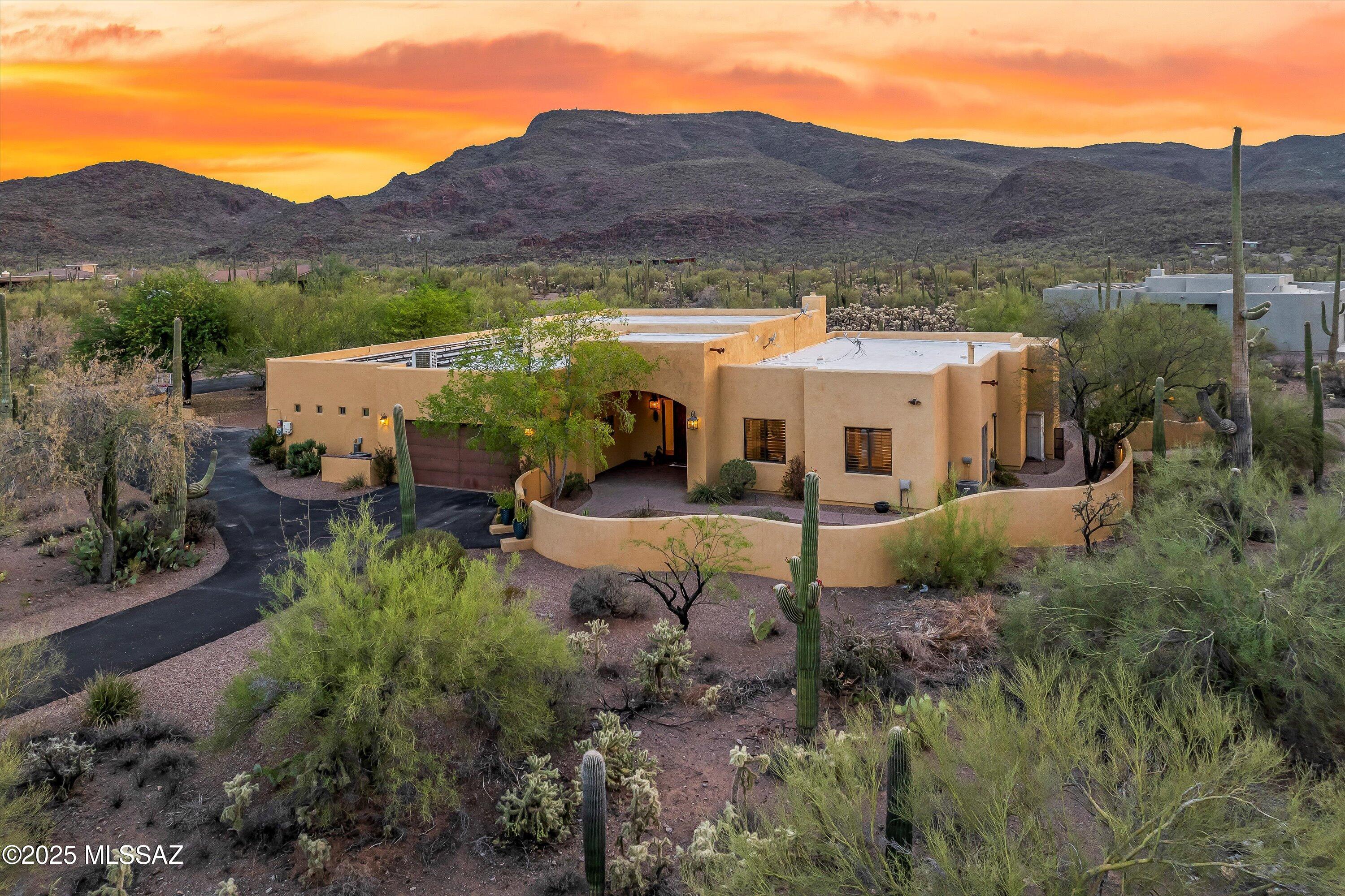 Price Improvement! Stunning 4,002sqft home in a gated enclave offering spectacular desert beauty. This 4 bed/4.5 bath home sits on a 3.31 acre parcel allowing you to enjoy incredible wildlife, 142 saguaros & trail access into Saguaro National Park West. Step inside to find stained concrete, hardwood floors & tile throughout the main living areas along w/upgraded carpet in bedrooms. Two gas fireplaces, modern kitchen with gas range & hood, Bosch refrigerator & dishwasher. Newer AC & water heater, whole-house water filtration & permitted additions add even more exceptional living space. Outdoor living shines with a deep extended L-shaped patio, well designed hardscape, gas fire pit w/wide-open desert & mountain views. 400A service with 200A sub-panel supports any need along with owned solar The upgraded interior features tall ceilings, exposed beams and large windows allowing for an abundant amount of natural light. Home is thoughtfully laid out and the flow of the home is outstanding. Upgraded primary with outdoor patio access and private fireplace are the perfect respite after a long day. Bedroom 2 doubles as an office/study with book shelving along with functional sliding ladder. Bedrooms 3 & 4 are ensuite and are separated by a multi-use family room. The possibilities are endless as to the functionality of this home layout and you'll feel blessed to be in one of the most scenic areas around. Keep in mind, your only 9 minutes to Continental Ranch shopping, 10 minutes to I-10, 13 minutes to the Tucson Premium Outlets and 15 minutes to Costco. Best of all worlds.