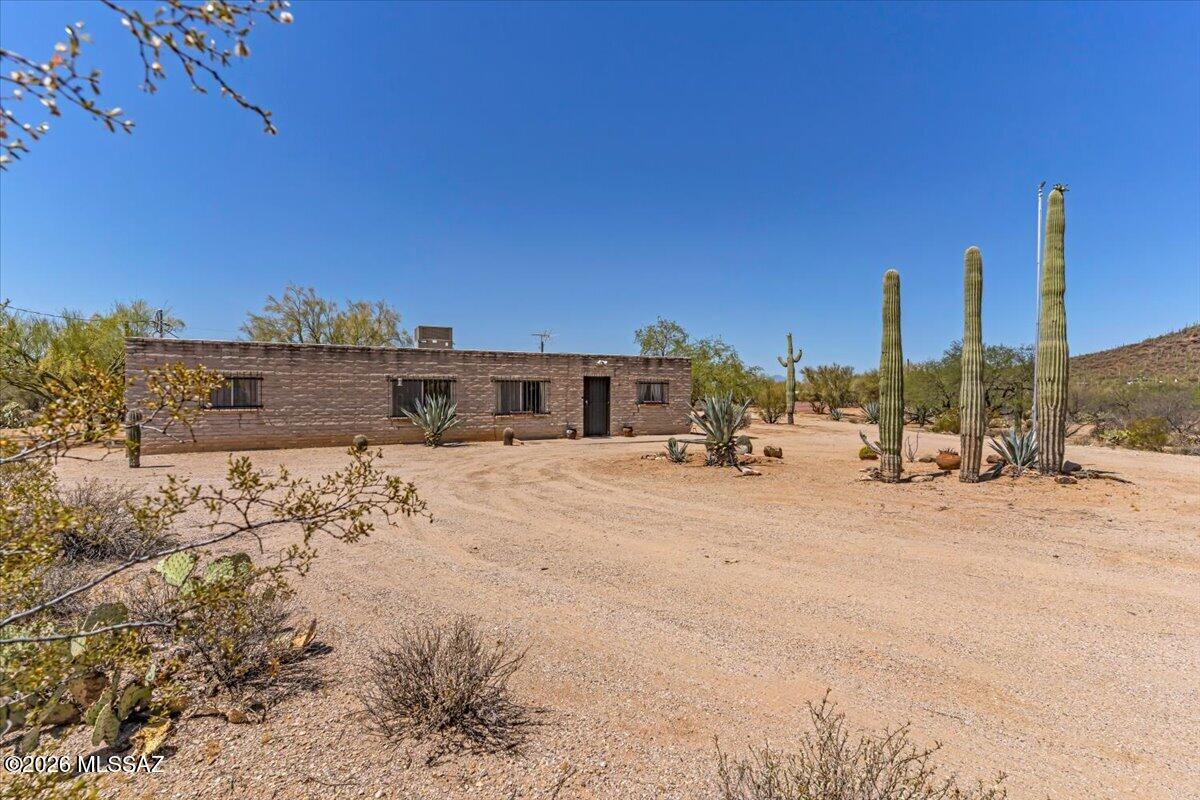 Perfect blend of privacy and potential on this expansive property spanning over 4 acres, where you are treated to breathtaking 360-degree mountain views from every angle. This estate is a dream for hobbyists and collectors alike, featuring a massive detached garage and workshop with ample space to house more than three vehicles alongside your tools and gear. Inside, the home boasts generously sized rooms that provide a sense of scale and comfort, including a kitchen updated with newer appliances. While the bones are solid and the setting is serene, this residence is truly a blank canvas ready for your new ideas and personal touch. Are you looking to create a modern equestrian retreat or a quiet desert sanctuary, this unique acreage offers the space and scenery.