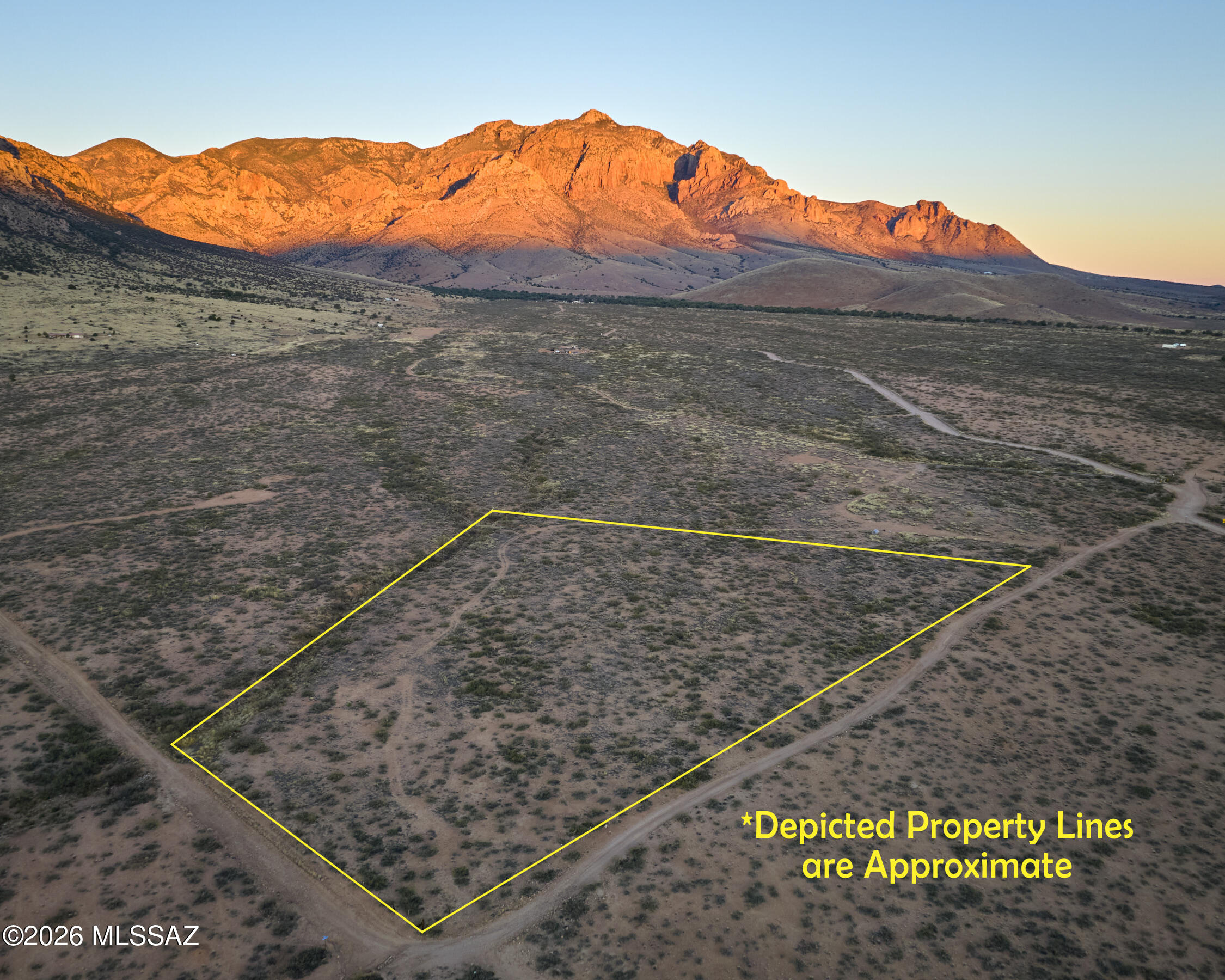 Enjoy expansive views of mountain bluffs and the San Simon Valley from this private 7-acre parcel in Portal, AZ. Multiple cleared, buildable homesites with established drive and walk paths make this property ready for your future plans. Protected from grazing for over 30 years, allowing native grasses and mesquite to thrive. Quick access to National Forest and State Trust Land for horseback riding, hunting, and hiking--ideal for outdoor recreation. No deed restrictions and no HOA offer flexibility for a custom build, off-grid living, or investment. Seller to pay for survey. Buyer to fence north boundary within 6 months of COE.  Call today!