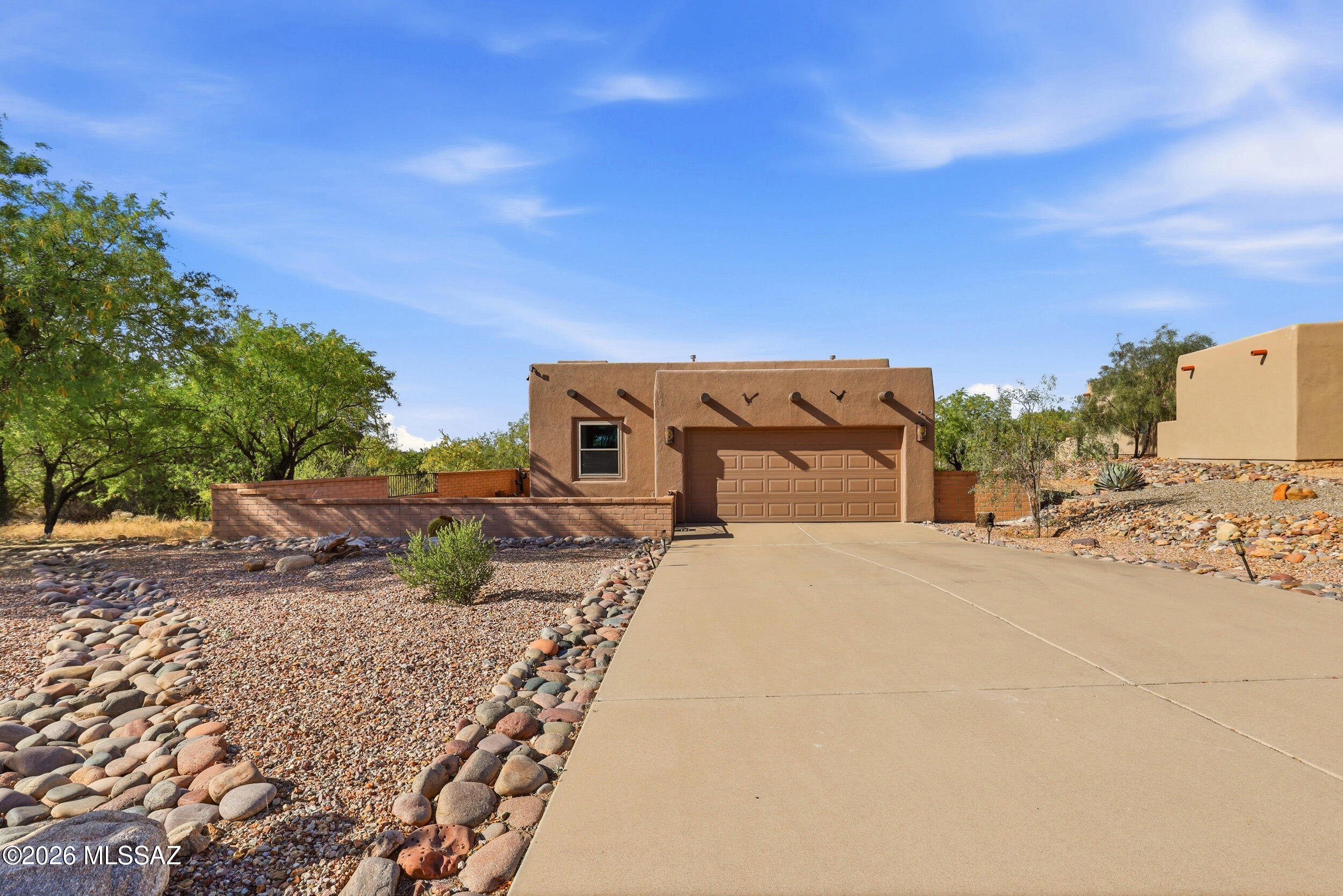 Nestled in the desirable Madera Reserve community of Green Valley, AZ, this well-maintained single-story home sits on a spacious cul-de-sac lot over half an acre, offering privacy and low-maintenance desert living. Featuring approx. 1,300 sq ft with 2 bedrooms and 2 baths, the functional split floor plan provides comfort and flexibility. The bright living area includes a cozy fireplace, tile flooring, and ceiling fans, flowing into the dining space and kitchen with gas range, microwave, dishwasher, and reverse osmosis. The primary suite offers a private retreat with dual vanities, while the second bedroom is ideal for guests or office use. Enjoy a screened-in porch perfect for year-round outdoor living. Additional highlights include a 2-car garage, central A/C, and forced air heating. Located in Green Valley Southeast near golf, recreation, shopping, and dining, this home is ideal for full-time or seasonal living.