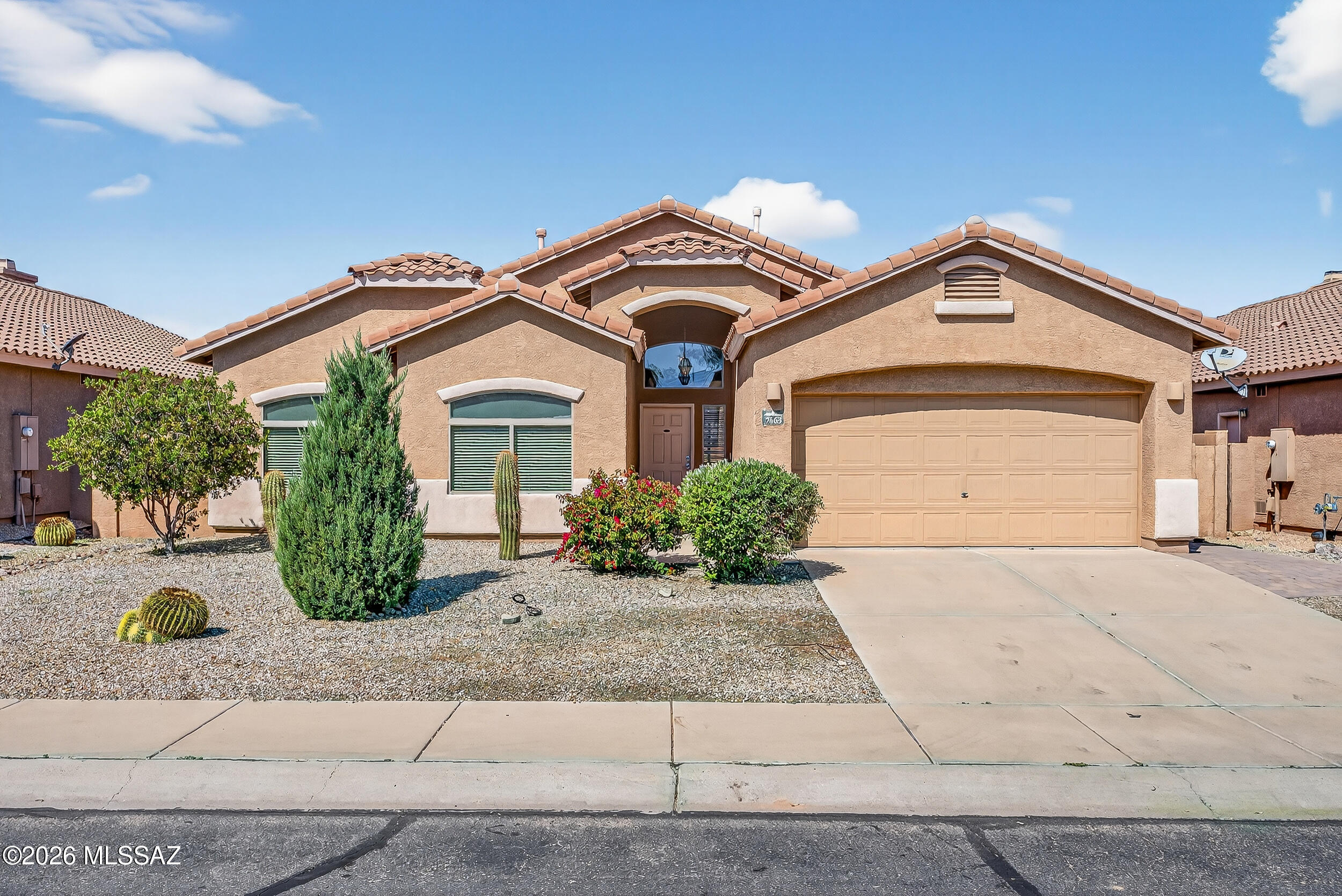 MODERN OASIS: 3BD/2BA, tile roof, 2-car-garage w/NO immediate rear neighbors!! Bright & open-concept w/soaring ceilings, 2 living/dining areas, arched doorways, NEW tile floors, NEW carpet, NEW int paint & 5 yr HVAC! Chef's kitchen boasts granite island, herringbone tile backsplash & generous storage. Spacious family rm w/fireplace flows to dining & covered patio. Owner's suite offers huge walk-in closet, luxurious roll-in shower, patio walk-out & dual vanity. Versatile bonus room perfect for a home office or den. Backyard oasis features sparkling replastered pool w/new motor, huge shade sail, covered patio, paver paths & low-maintenance desert landscaping. Home is approx half mi to Crossroads @ Silverbell Park: baseball, playground, dog park, tennis, batting cages, volleyball, splashpad!!