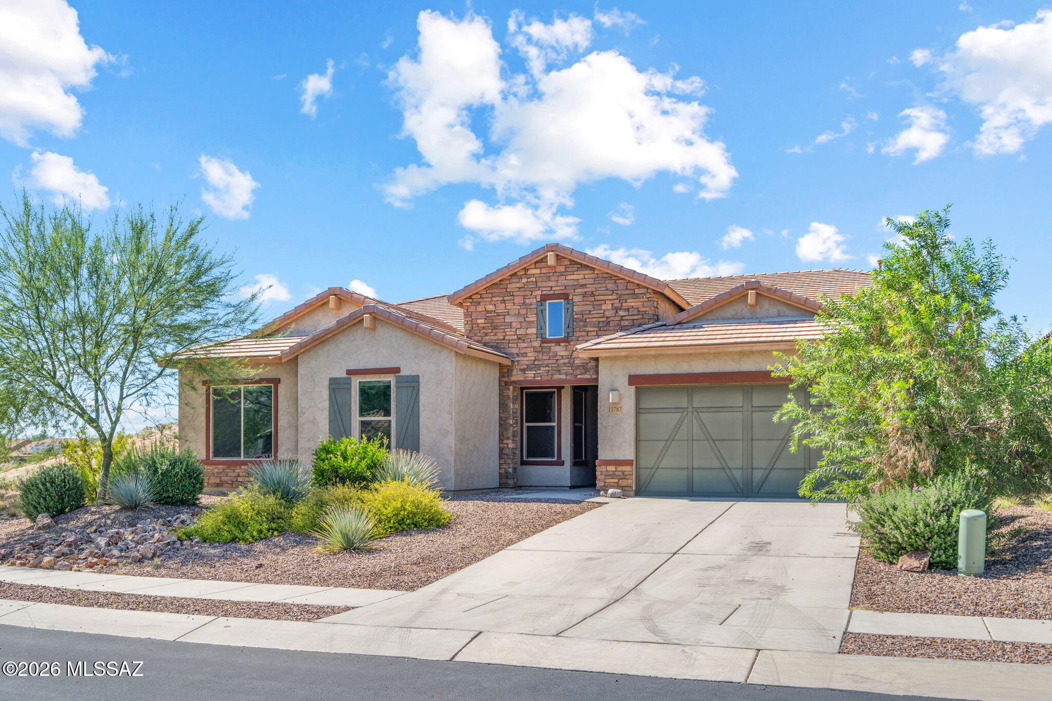 Gated Villages at Silverhawke living in the heart of Oro Valley! Built in 2021, this 4 bed, 3 full bath home delivers 3,045 sq ft of modern design and space. The open great room flows into a large kitchen with quartz counters & oversized island, made for hosting holidays and everyday gatherings alike. Retreat to the private primary suite with a soaking tub & walk-in closet. With three more bedrooms and a flex space for home office, or gym, you have plenty of room. Step outside to covered patio & Catalina Mountain views. Community perks include green spaces, playgrounds, a basketball court and covered picnic pavilions, all minutes from shopping, dining & trails. Nearly new, zero wait. Homes here don't last, so book your showing today!