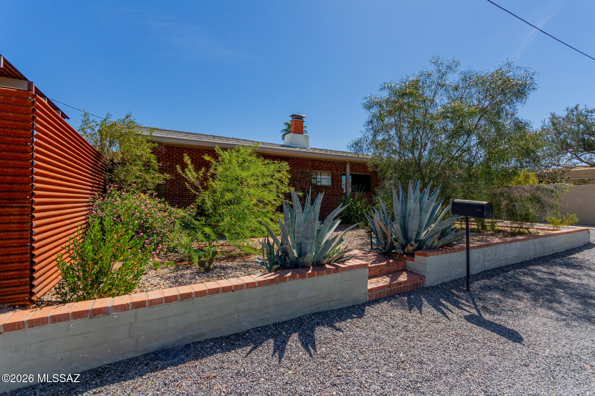 Welcome to this charming home in the heart of Tucson, offering beautiful Catalina Mountain views and a prime corner lot location. This inviting residence features 1,145 square feet with 2 bedrooms and 1 full bath, blending comfort and functionality. A cozy wood burning fireplace creates a warm and welcoming living space, while updated vinyl plank flooring throughout the living areas and bedrooms adds a modern touch. The bright, updated kitchen is equipped with stainless steel appliances and includes a washer and dryer for added convenience. Step outside to an expansive, fully landscaped and fenced rear yard complete with two ramadas, artificial turf, and a raised garden bed, perfect for relaxing or entertaining. Additional highlights include a quaint covered front porch, off street parking with a large metal gate accessed from Pima Street, and additional off-street parking in the front along Palo Verde Boulevard. Ideally located across from Catalina High School and just minutes from elementary/middle schools, shopping, dining, the Arizona Inn, Banner University Medical Center, and the University of Arizona and more, this home offers both convenience and charm. Do not miss this incredible opportunity!