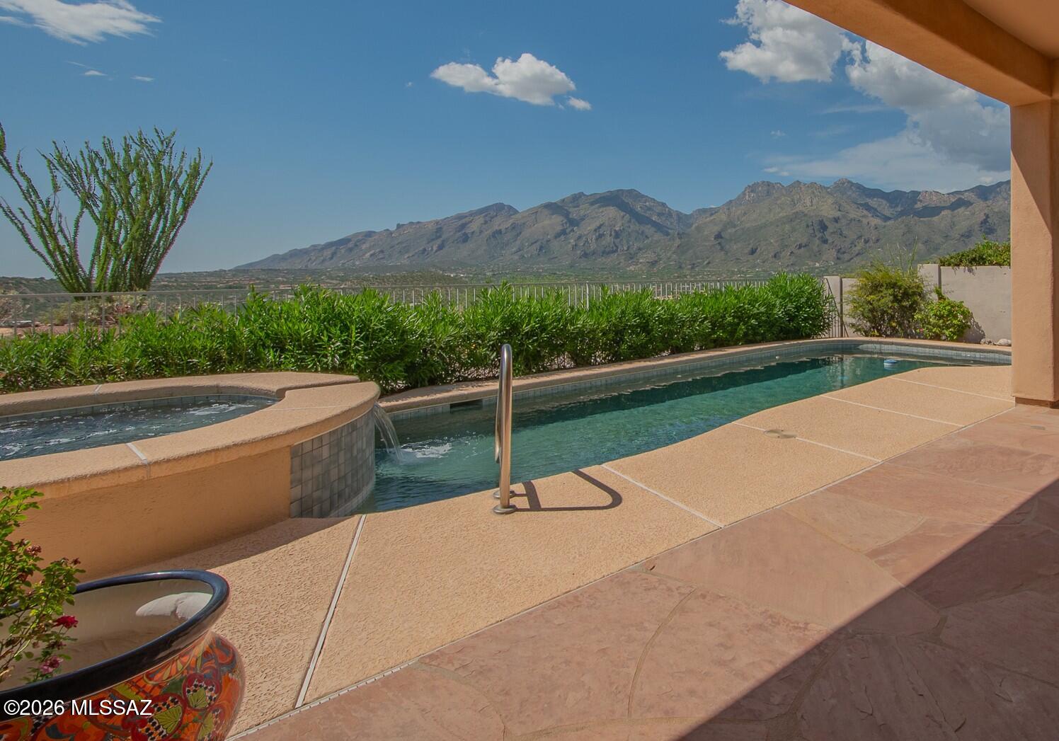 Spectacular panoramic mountain and valley views await in this gated Sabino Mountain home positioned at the top of the subdivision. Designed for luxury living, this Tucson sanctuary features soaring high ceilings, a gas fireplace in the great room, and an upgraded chef's kitchen with premium granite countertops and rich cabinetry. Wake up to mountain sunrises in the primary suite, complete with a spa-like bath featuring a deep soaking tub, walk-in shower, and expansive closet. Step outside to a resort-style backyard with a covered patio, custom PebbleTec pool, and spa--perfect for enjoying vibrant Arizona sunsets. Minutes from Sabino Canyon Recreation Area, golf, shopping, and dining.