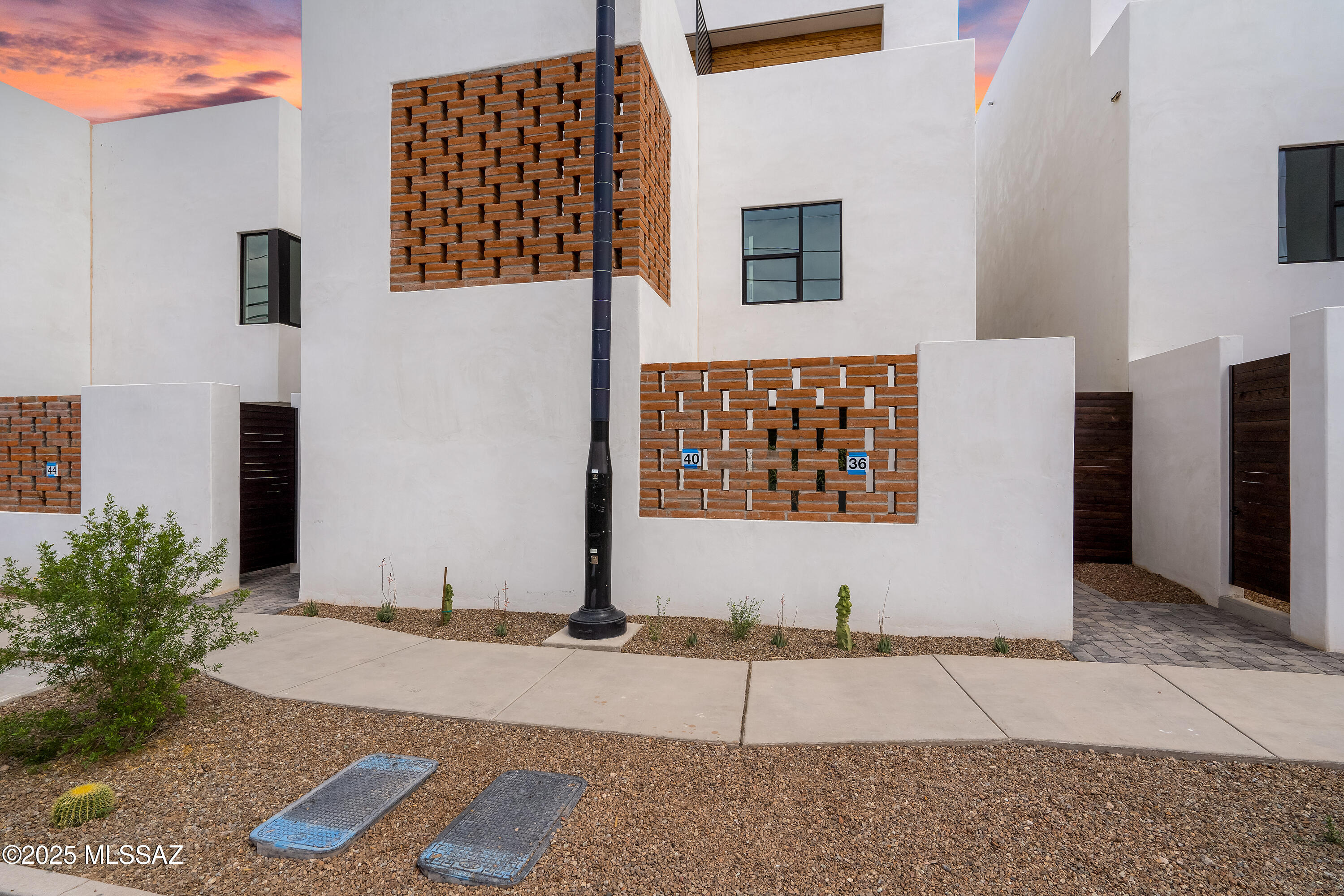 ASK US ABOUT 4.99% BUILDER RATE INCENTIVE! WE WILL PAY BUYERS CLOSING COST TOO! Welcome to the epitome of upscale urban living in Tucson's vibrant Five Points neighborhood, where modern sophistication meets historic charm. This is The Row at 18 W. 18th, an exclusive 16-unit desert contemporary townhome subdivision featuring a harmonious blend of luxury & location, boasting solid white, smooth stucco construction with authentic adobe brick accent walls. Meticulously designed by HA|RU architects, in collaboration with Durazo Construction, honors the ethos of Southern Arizona with clean lines and a contemporary eel that maximizes natural light, creating an open, and airy ambiance throughout each home. The kitchens are designed for style and functionality, complemented by custom Davis Kitchen cabinetry that embody superior craftsmanship and luxurious design. The primary bedrooms offer en-suite baths with custom closets by Classy Closets, offering ample storage solutions. These thoughtfully designed spaces are perfect for the discerning homeowner who values quality and attention to detail, captured throughout each space. Located in the heart of vibrant Five Points, where 5 historic and distinct neighborhoods meet, these townhomes offer unrivaled walkability and access to a plethora of amenities and authentic, local restaurants. Residents will enjoy a dynamic lifestyle with everything at their doorstep from artisan coffee shops to organic grocers, eclectic dining, and vibrant community events, all with a Walk Score of 84 and a Bike Score of 98. This is more than a home; it is a lifestyle rooted in convenience, culture, and modern luxury, seamlessly blending with the historical beauty of Tucson. Embrace the opportunity to live in a place where contemporary design and historic charm coexist in perfect harmony.
