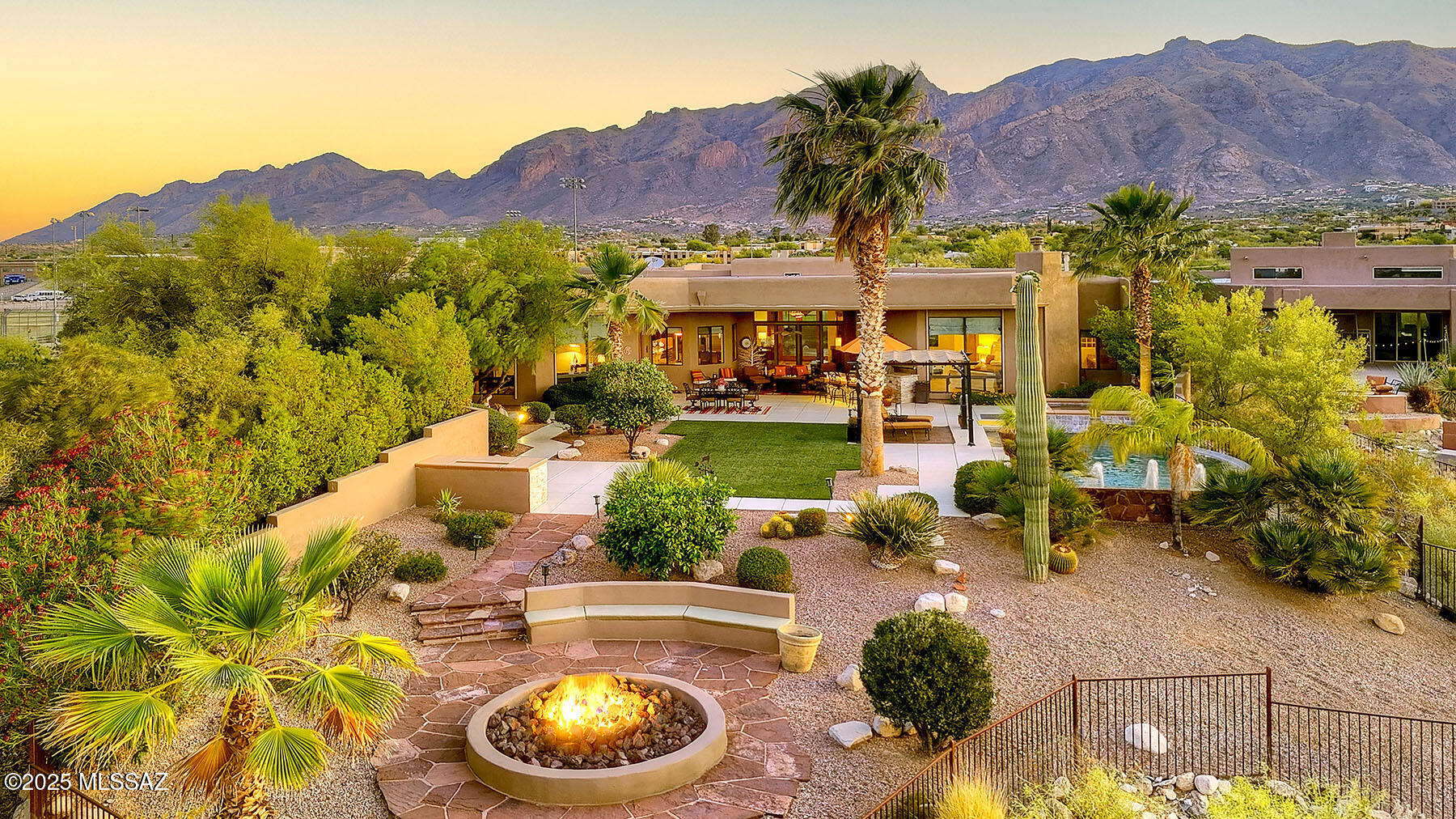 Exquisite custom home with panoramic city & mountain views and premier upgrades.  Set atop a 1.56-acre ridgetop lot, this stunning 2006 custom-built residence offers sweeping, unobstructed views of the city skyline and surrounding mountains. A brick paver driveway leads to a charming courtyard entry, opening into a dramatic foyer with soaring ceilings, expansive windows, and breathtaking vistas from nearly every room.  Inside, timeless luxury meets modern comfort. Elegant 24-inch travertine tile floors, coffered ceilings, and a gourmet chef's kitchen featuring granite countertops, stainless steel appliances, a professional-grade gas range, and solar shade screens on most windows, create a space that is both beautiful and functional. The spacious primary suite is a true retreat boasting a steam shower and high-end finishes.  Meticulously maintained and thoughtfully enhanced, this home showcases a long list of recent upgrades, including: fully owned solar system (2024) for exceptional energy efficiency; new HVAC systems (2022), dual air conditioners, furnaces, and water heaters; high-end theatre sound system in the family room for immersive entertainment; fresh exterior paint (2024) and interior paint (2025) for a modern, polished look; new carpeting (2021) in the family room, primary suite, and walk-in closet; backyard oasis remodel (2021): new landscaping, granite bar, built-in grill with stacked stone surround and LED lighting, stacked stone fireplace and spa accents, plus low-maintenance artificial turf; Enviro System Whole House Water Conditioning for superior water quality.  Located in the Catalina Foothills School District, this home offers the rare combination of refined desert living with no HOA and convenient access to premier shopping, dining, golf, and amenities. This is more than a home, it's a lifestyle. Don't miss the opportunity to own a luxurious, energy-efficient property in one of Tucson's most desirable settings.