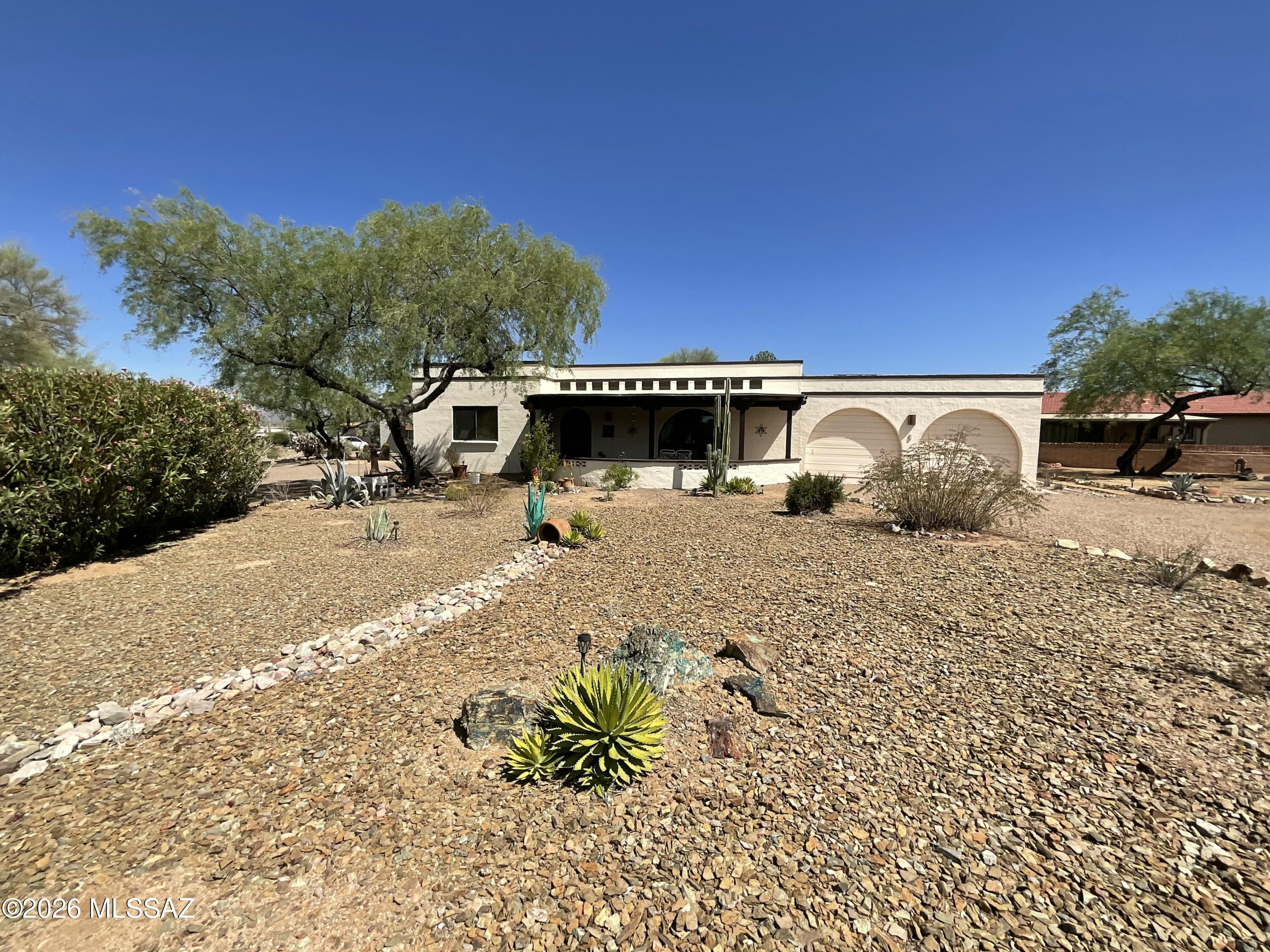 Unique La Canada Desert home in 55+ Active Retired community. Welcome to this relaxing garden backyard with water feature, custom wall mural, comfortable lounge area and a view of mountains. Oscar may stop by for breakfast, the resident lizard. Evenings can bring the surrounding migratory creatures.  Classic front veranda welcome you in and keep you cool on the warm days. Custom is a pleasant word in this home. From the fireplace to the mural outback. Owned solar and use of mini splits keep you very comfortable throughout at a fraction of the cost. Are you a hobbiest or have Social Media webcast needs? The perfect area is off the Arizona Room. Comfortable bedrooms and well appointed baths round out this well maintained home.  Most furniture included. See pics.