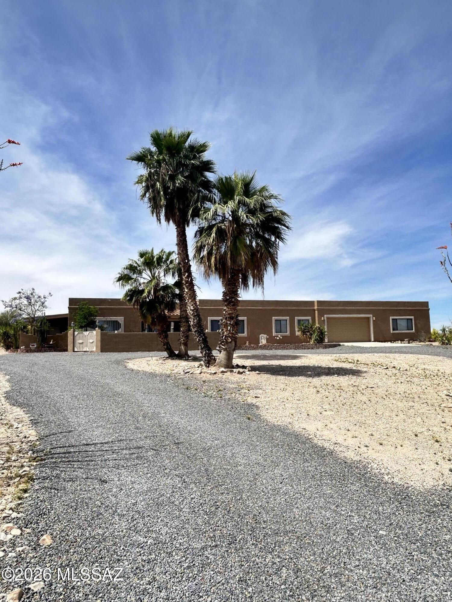 Set on a sprawling 1.08-acre lot with breathtaking views, this one-of-a-kind property is ready to impress! A welcoming courtyard entry and serene desert landscaping create a striking first impression, while the 2-car garage adds everyday convenience. 

Remodeled between 2006-2008, the main residence features 3 bedrooms plus a versatile bonus room currently used as a beauty shop--ideal for conversion into a  home office, or studio. In 2005, a 6-car garage was built, offering exceptional space for vehicles, storage, or a workshop. Inside, you'll find spacious living areas designed for both comfort and entertaining, along with a well-appointed kitchen featuring beautiful hickory cabinetry and elegant marble countertops. The primary suite is a true retreat, complete with a luxurious ensuite bathroom offering a garden air tub, dual sinks, and two separate toilets for added comfort and privacy.

An attached guest house with its own private entrance provides exceptional flexibility--ideal for extended family, visitors, or rental income potential.

Step outside to a low-maintenance backyard where you can relax and take in the peaceful surroundings and stunning views. This unique property truly has it all--don't miss your opportunity to make it yours!